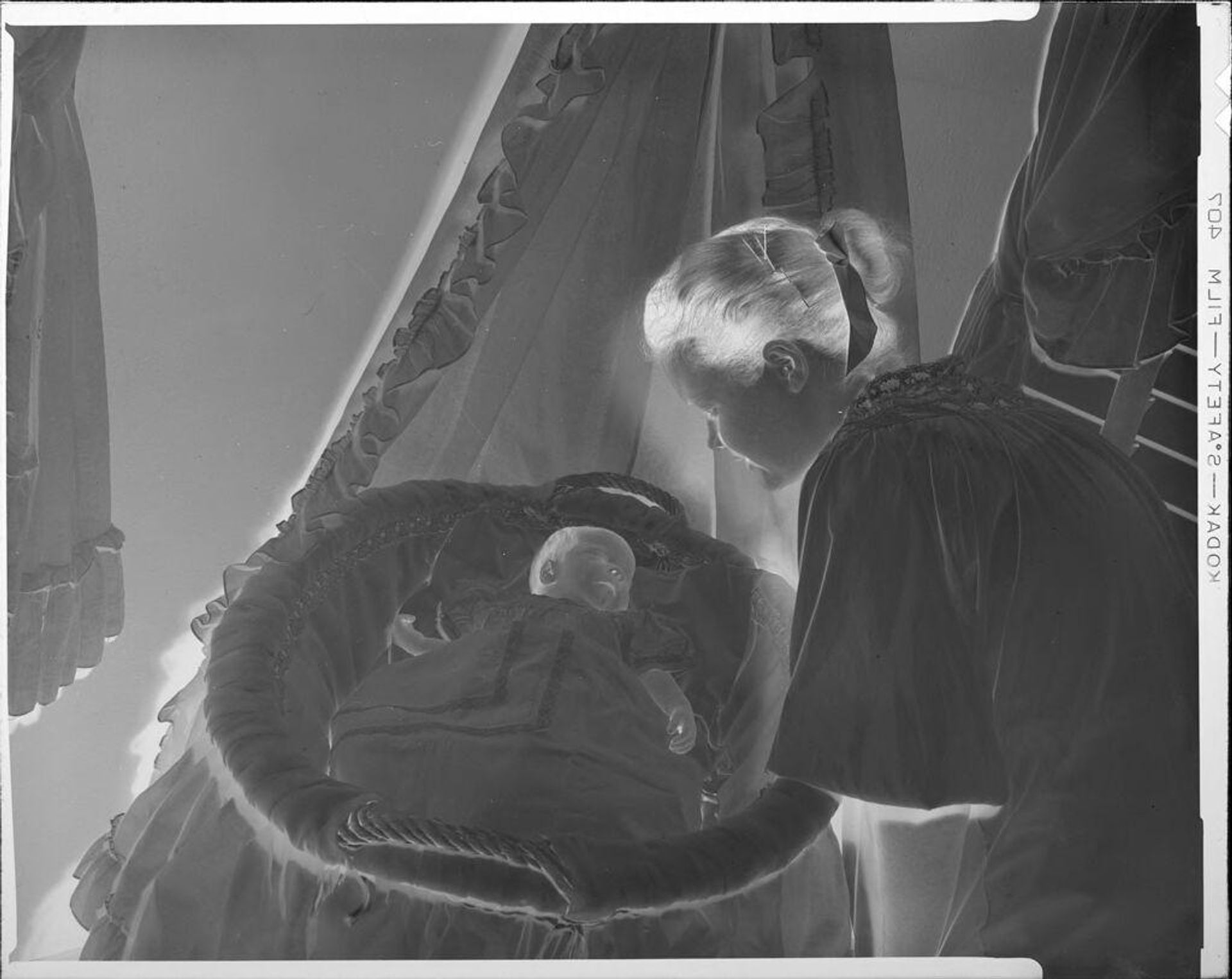 Untitled (young woman looking at baby) by C. Bennette Moore