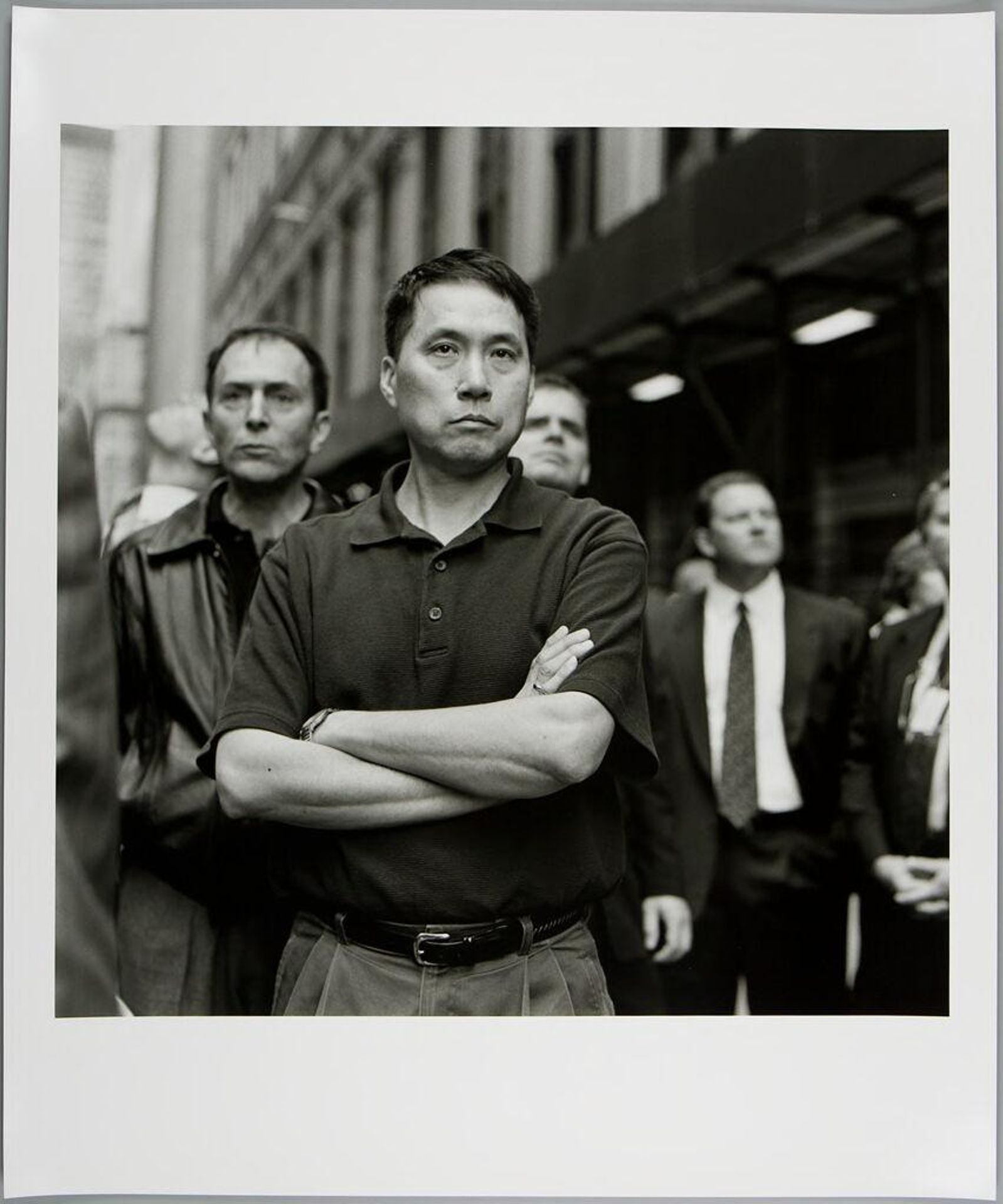 Untitled (man in polo shirt with crossed arms) by Kevin E. Bubriski