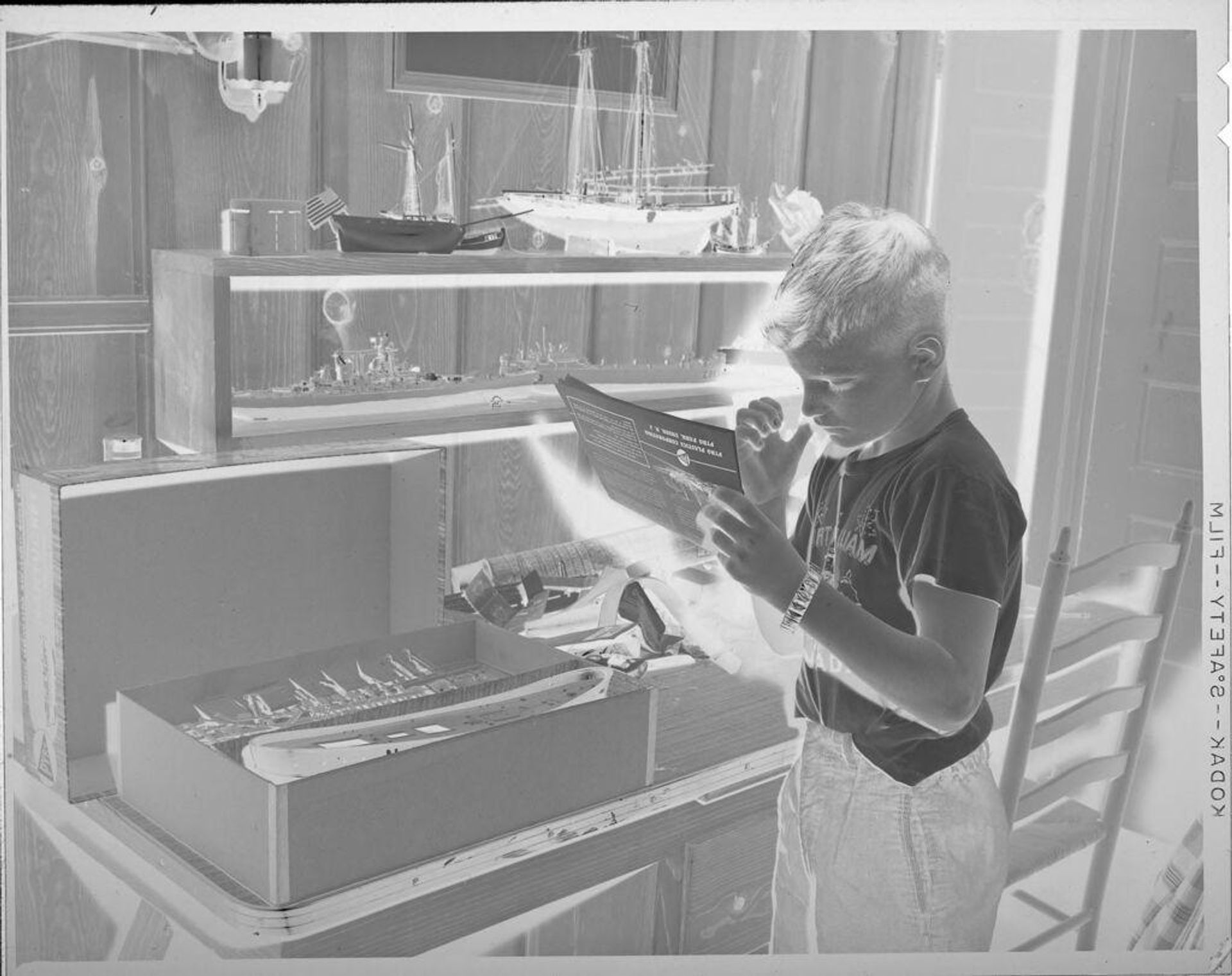 Untitled (boy with model boats) by Lucian and Mary Brown