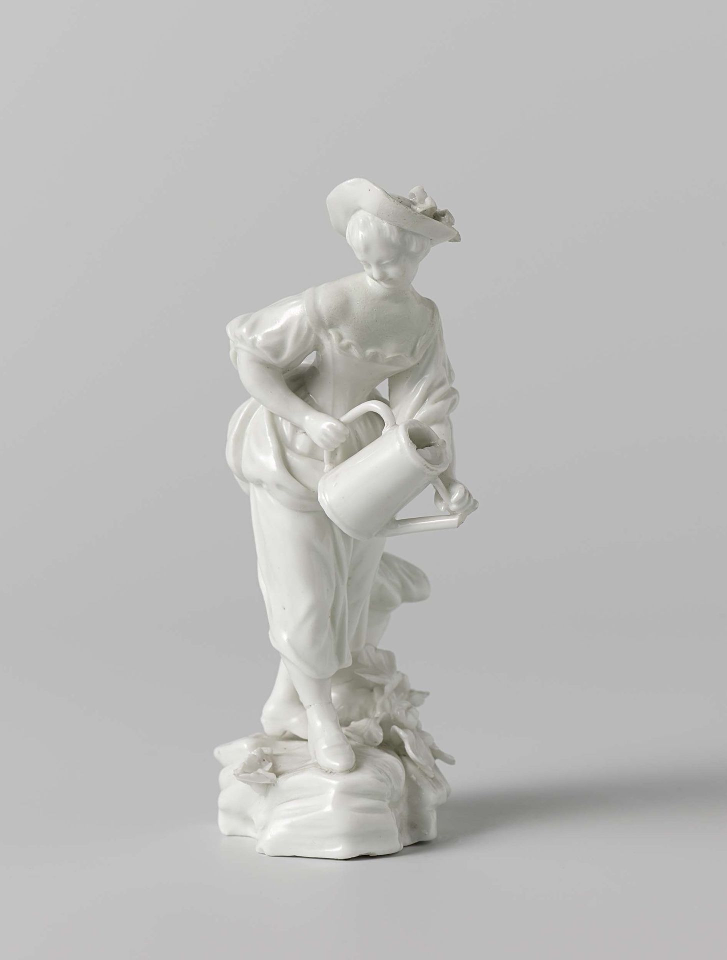 Figure of a woman with a watering can by Doornik