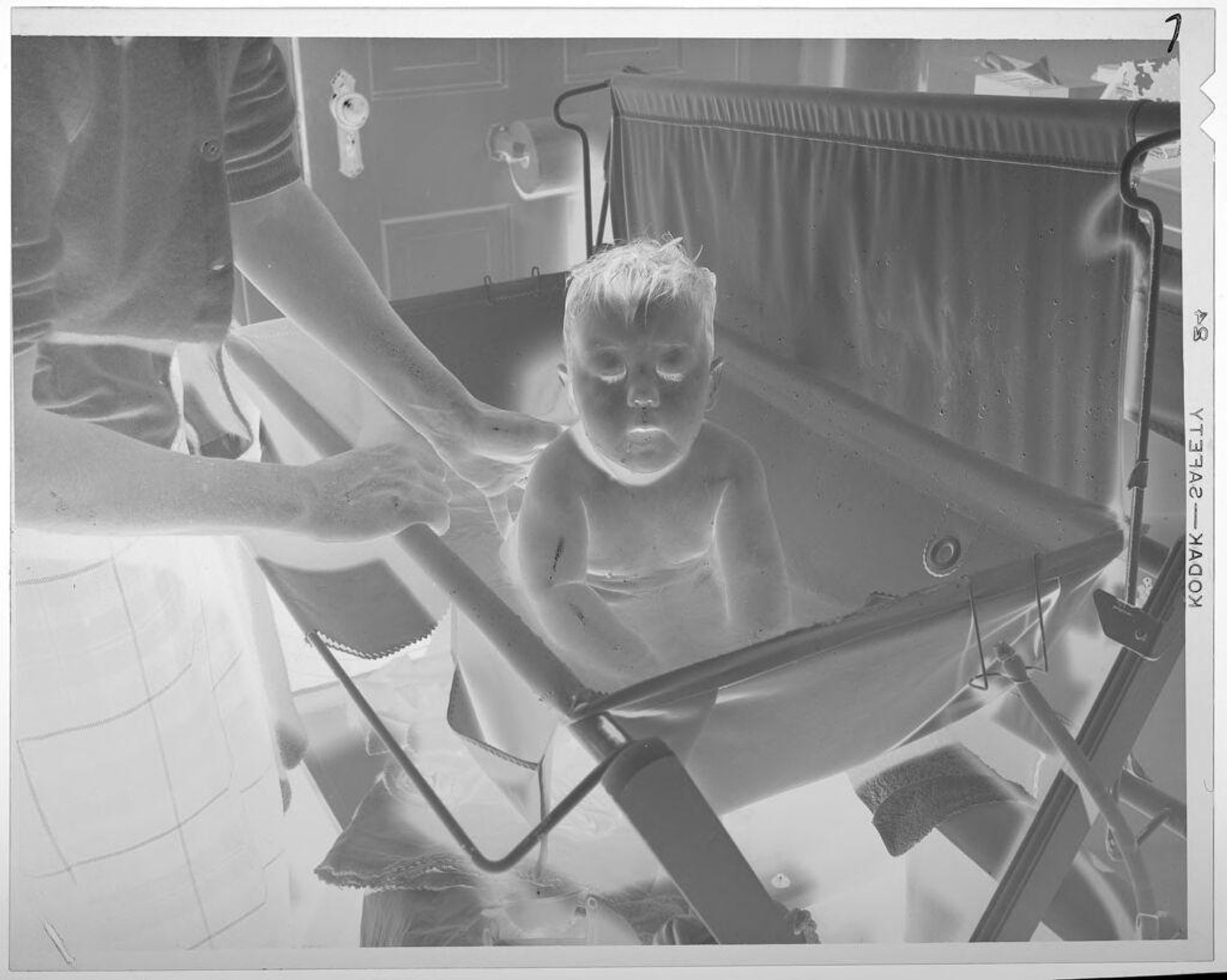 Untitled (baby sitting up in small bath tub) by Lucian and Mary Brown