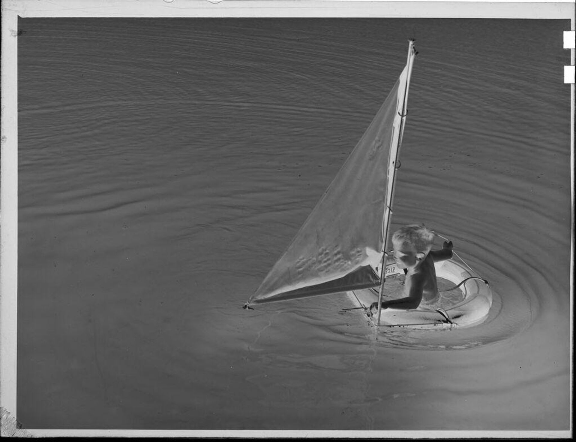 Untitled (little boy in small sailboat) by Lucian and Mary Brown