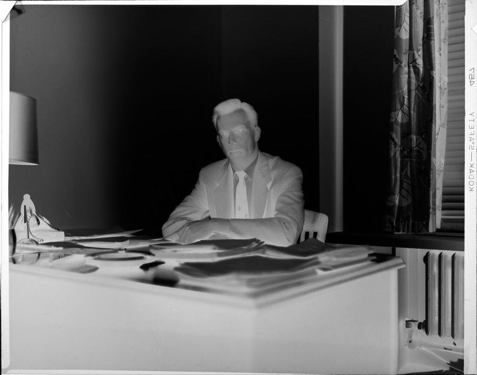 Untitled (man sitting at desk) by Peter James Studio