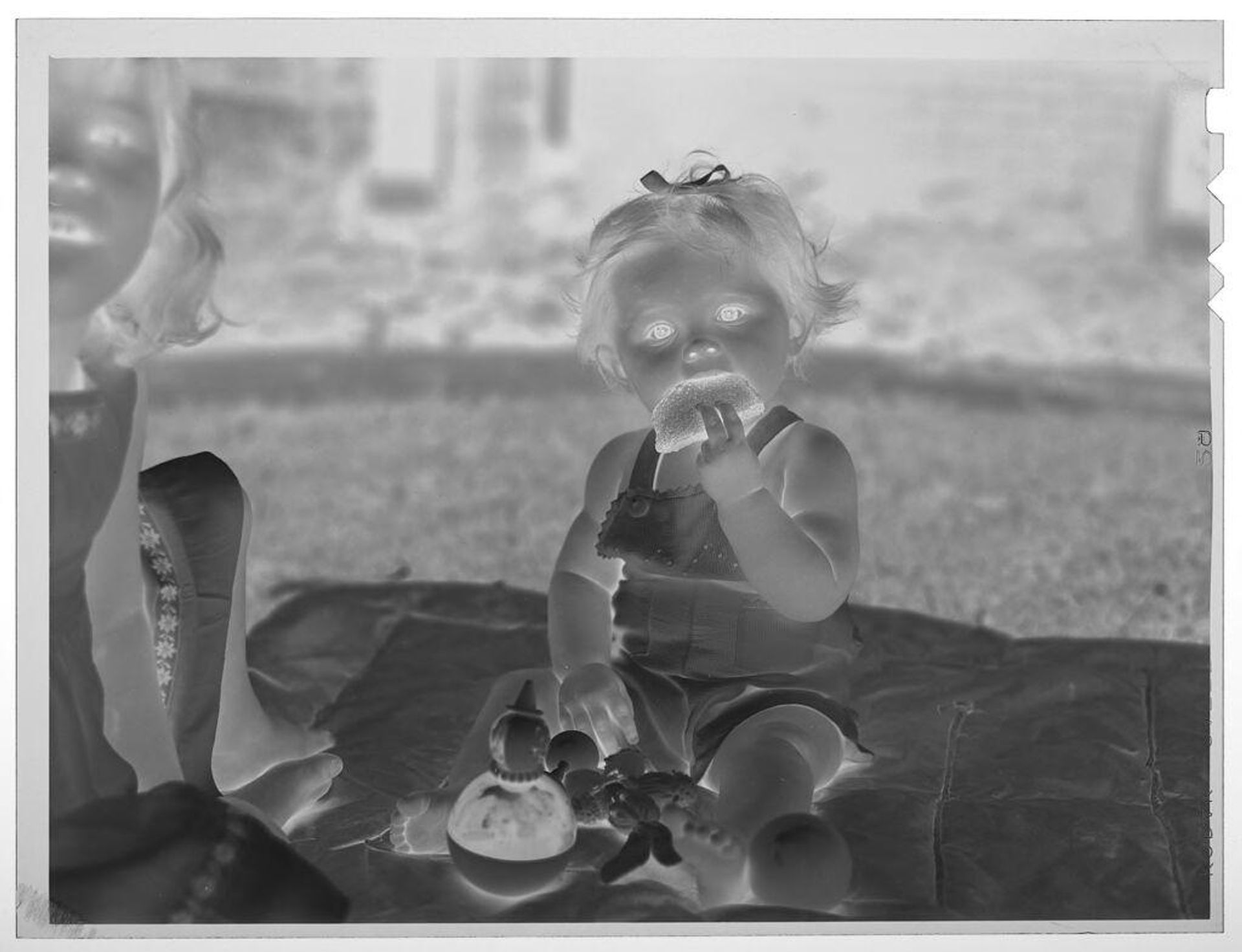Untitled (baby eating toast) by Lucian and Mary Brown