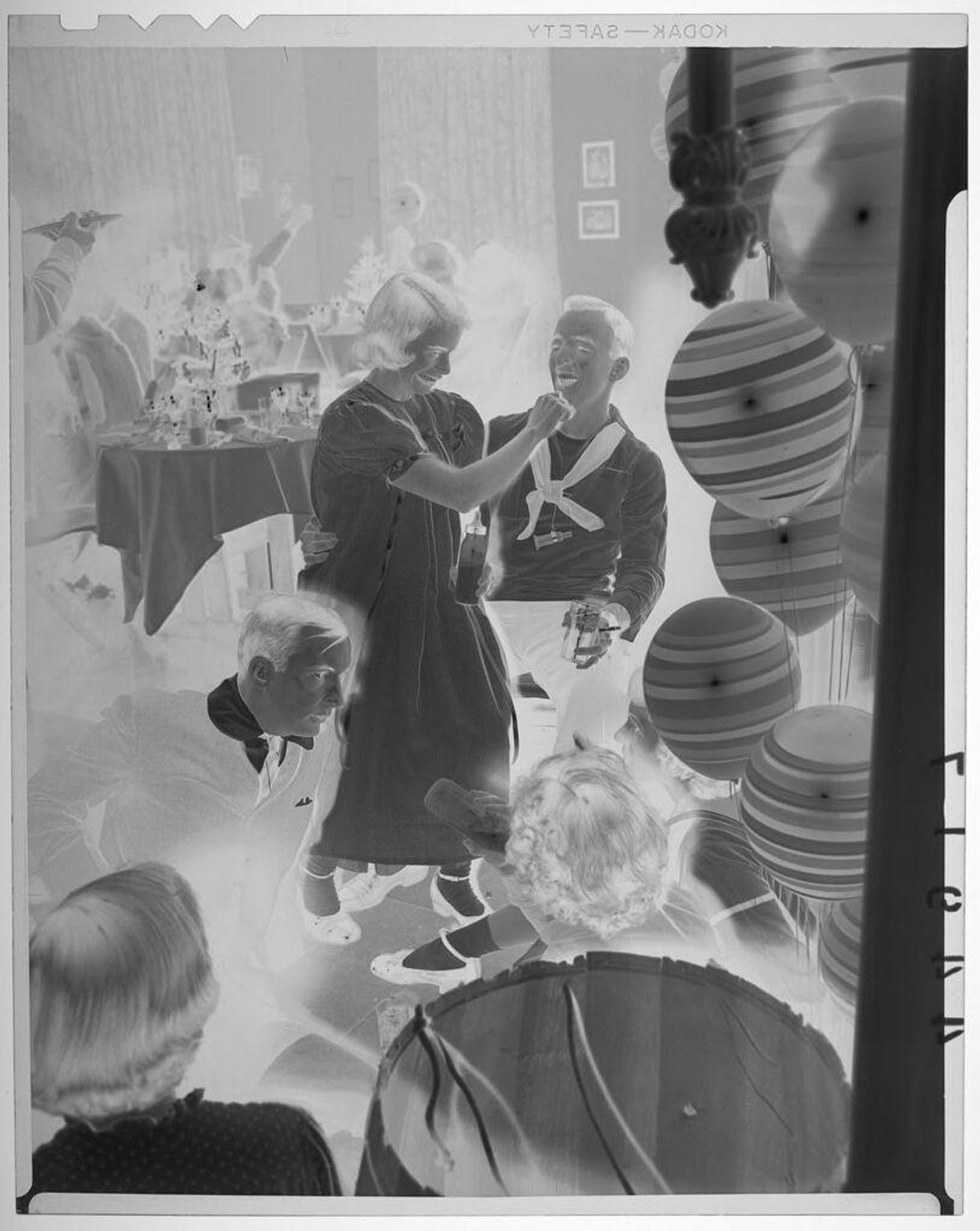 Untitled (young woman in costume pretending to punch young man in sailor suit at party) by Martin Schweig