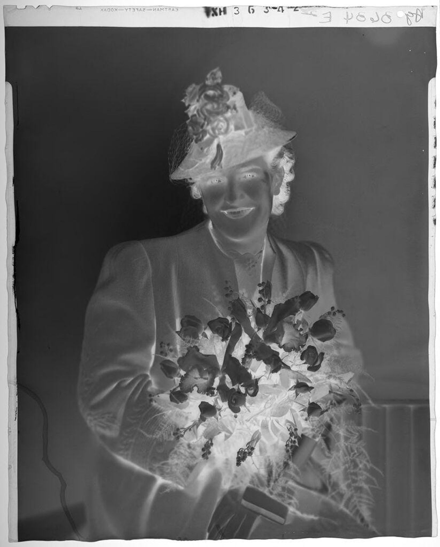 Untitled (portrait of woman seated in flower hat holding bouquet) by Paul Gittings