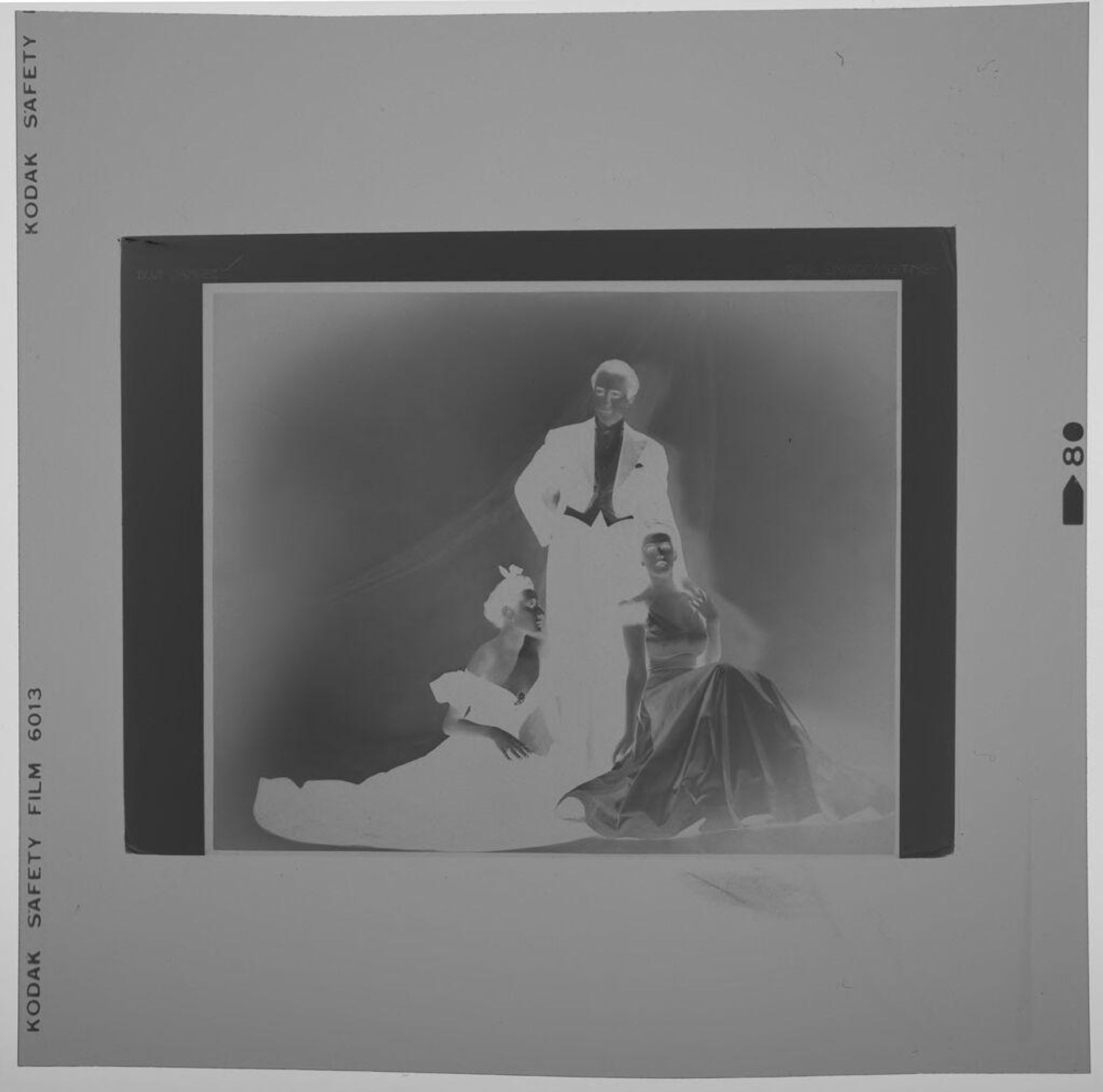 Untitled (photograph of "Blue Danube": two women in gowns kneeling by man in tuxedo) by Paul Gittings