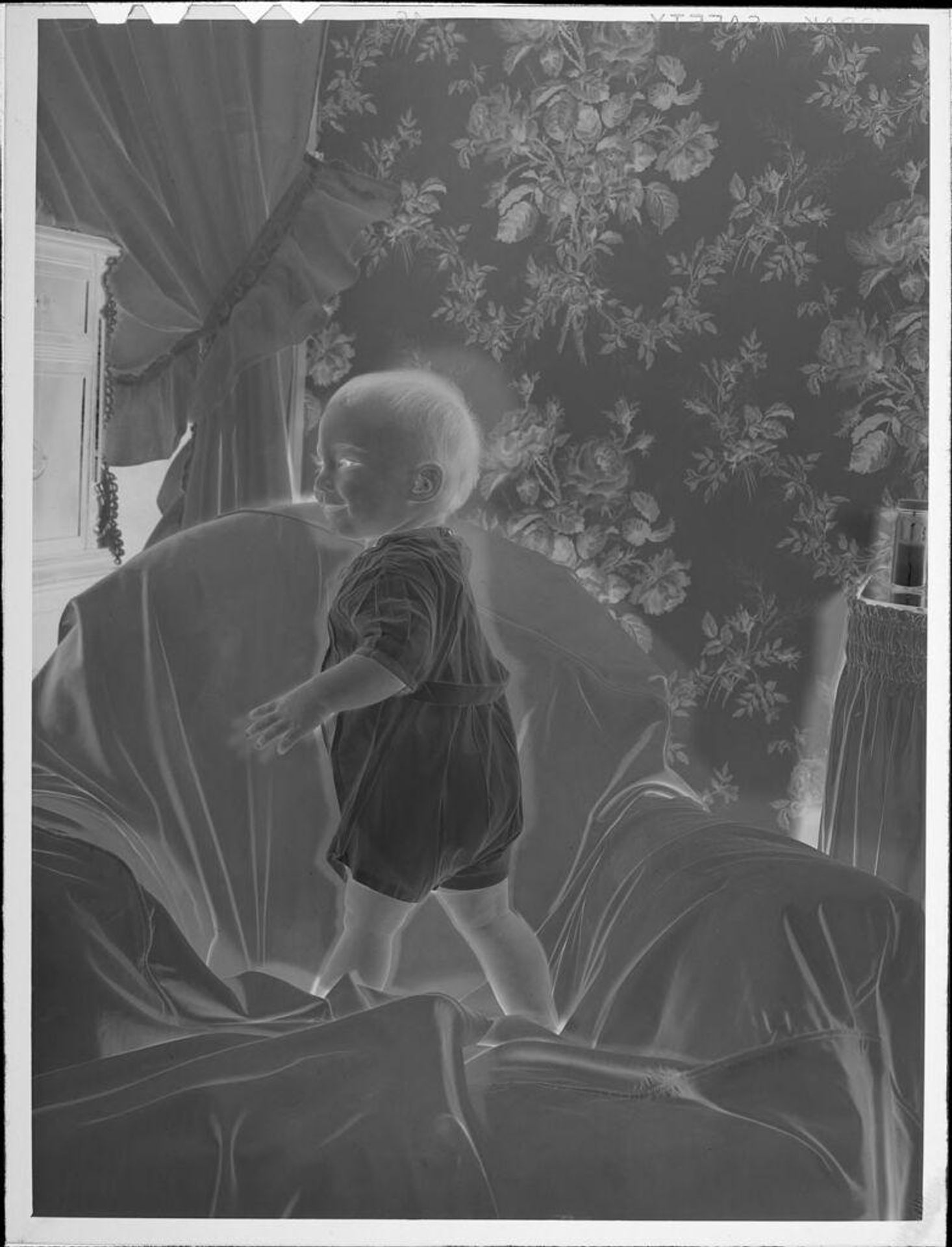 Untitled (baby standing on chair) by Lucian and Mary Brown