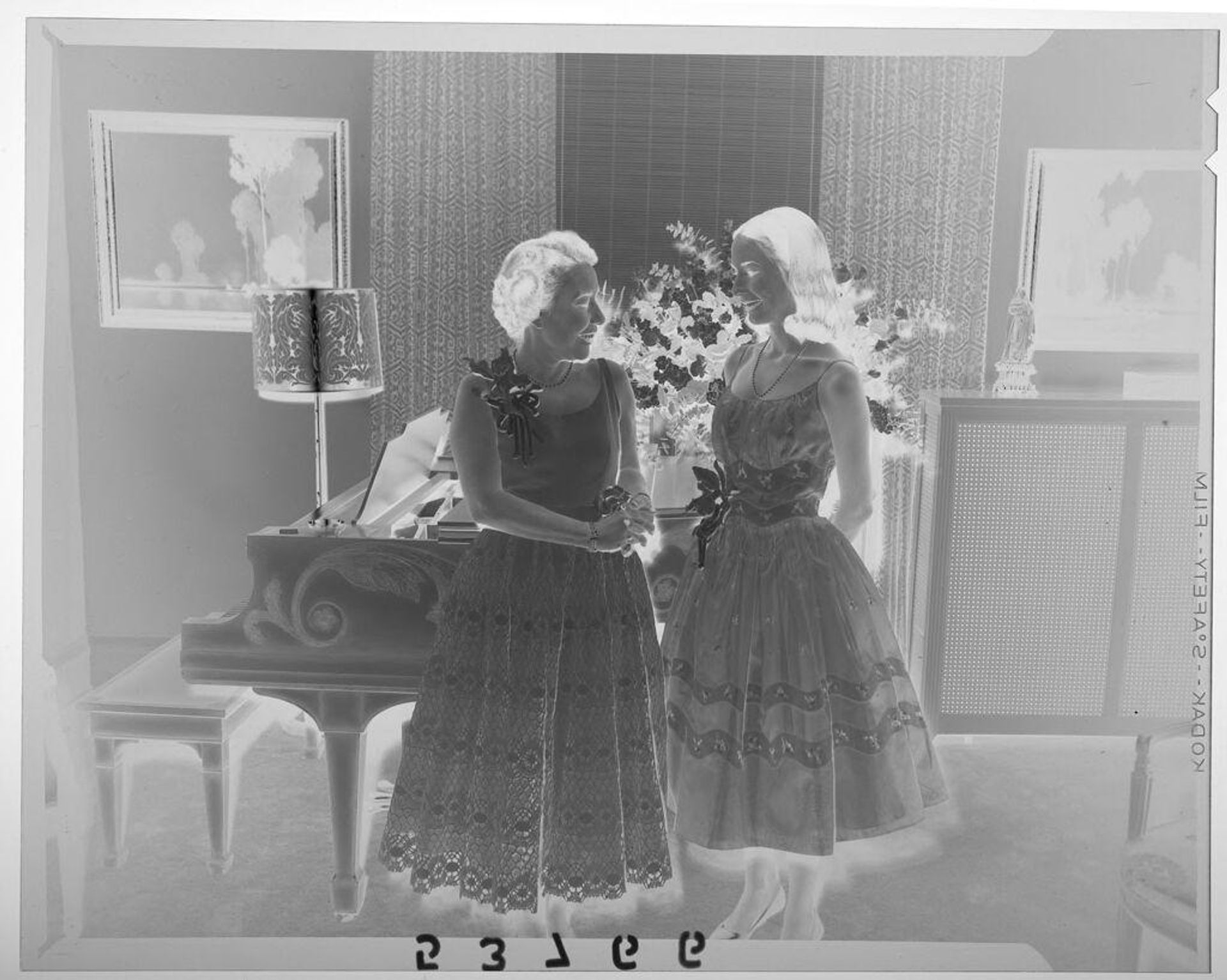 Untitled (young women and mother posed looking at each by piano in fancy room) by Martin Schweig