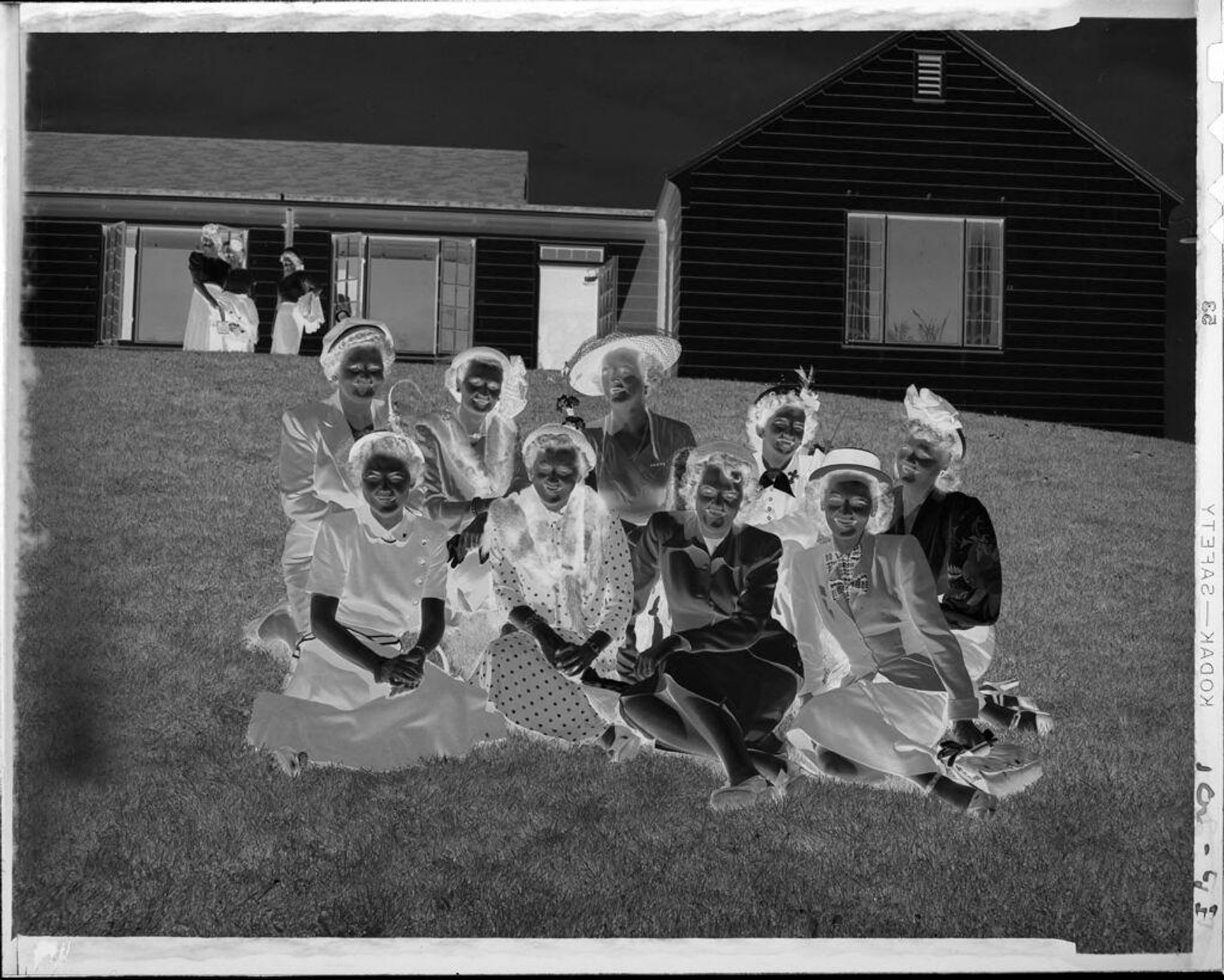 Untitled (group of women sitting on lawn) by Robert Burian