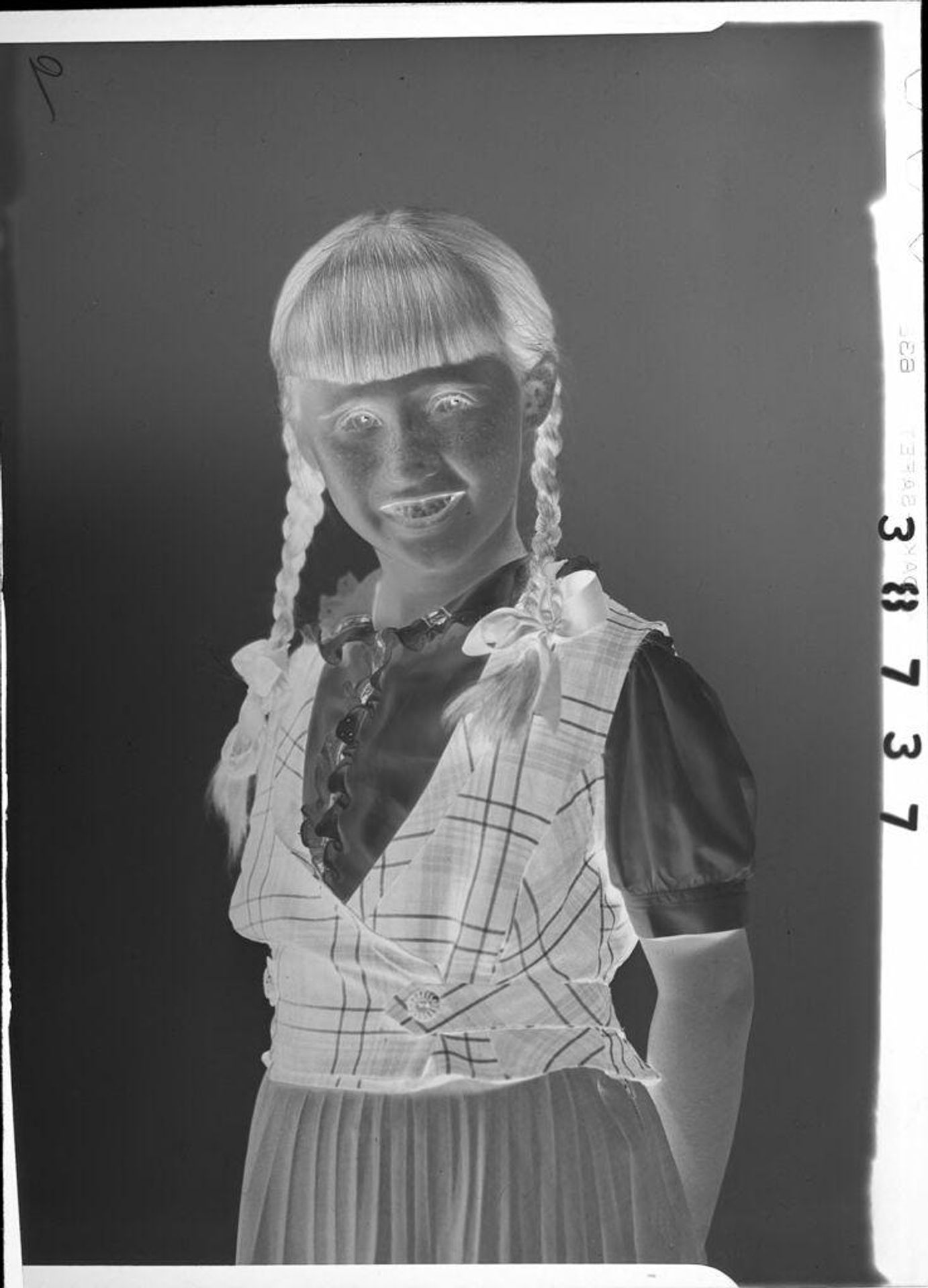 Untitled (girl with braids in hair) by Lainson Studios