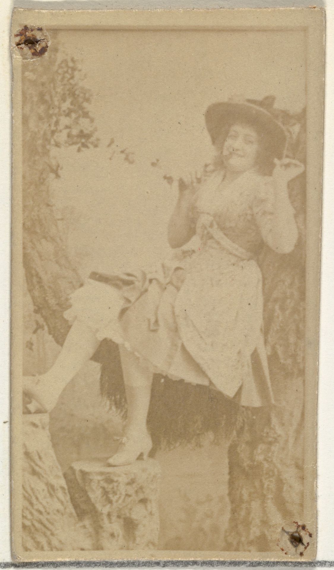 [Actress in studio reclining against prop trees], from the Actors and Actresses series (N145-8) issued by Duke Sons & Co. to promote Duke Cigarettes by W. Duke, Sons & Co.