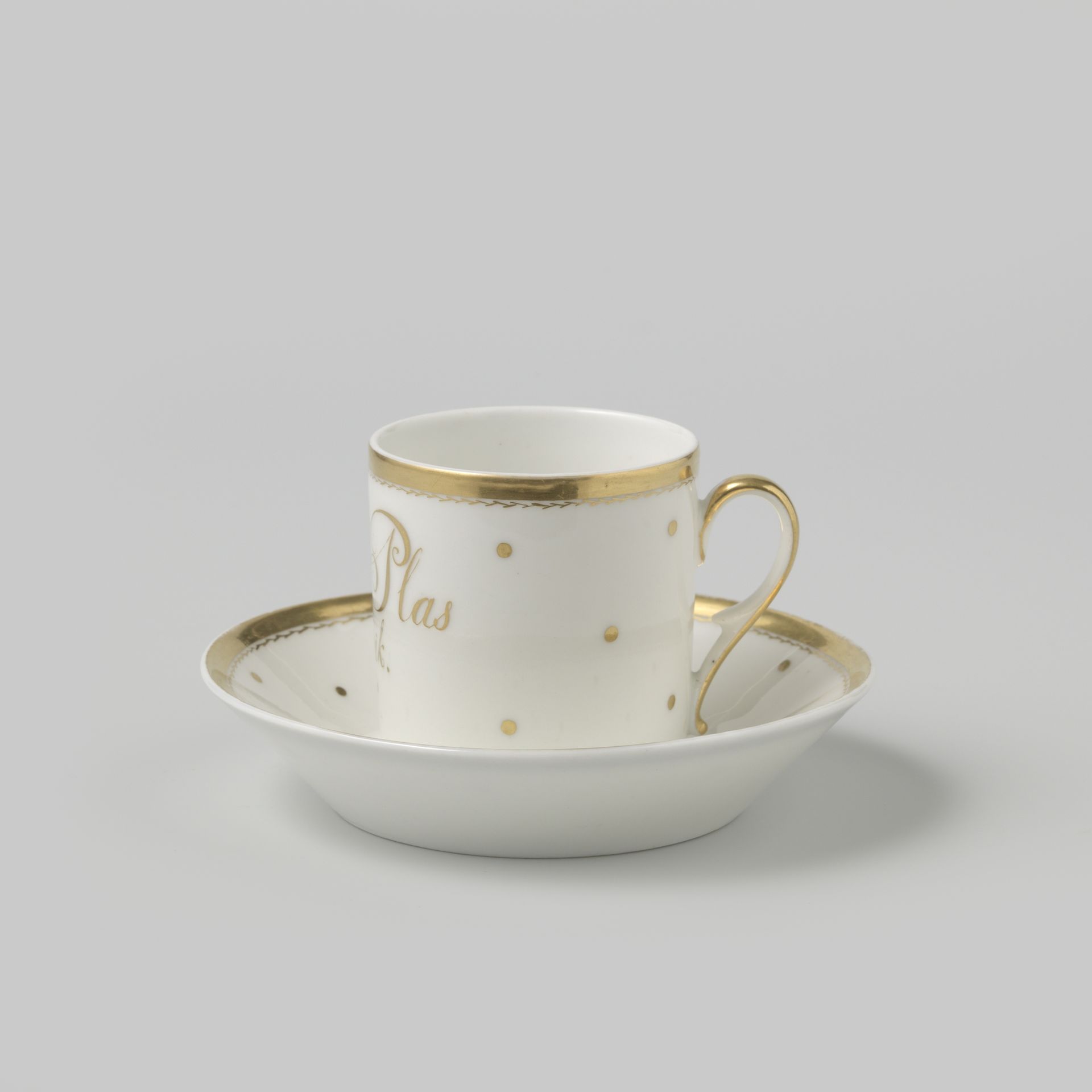 Cup and saucer with an inscription or medallion among dots by Anonymous