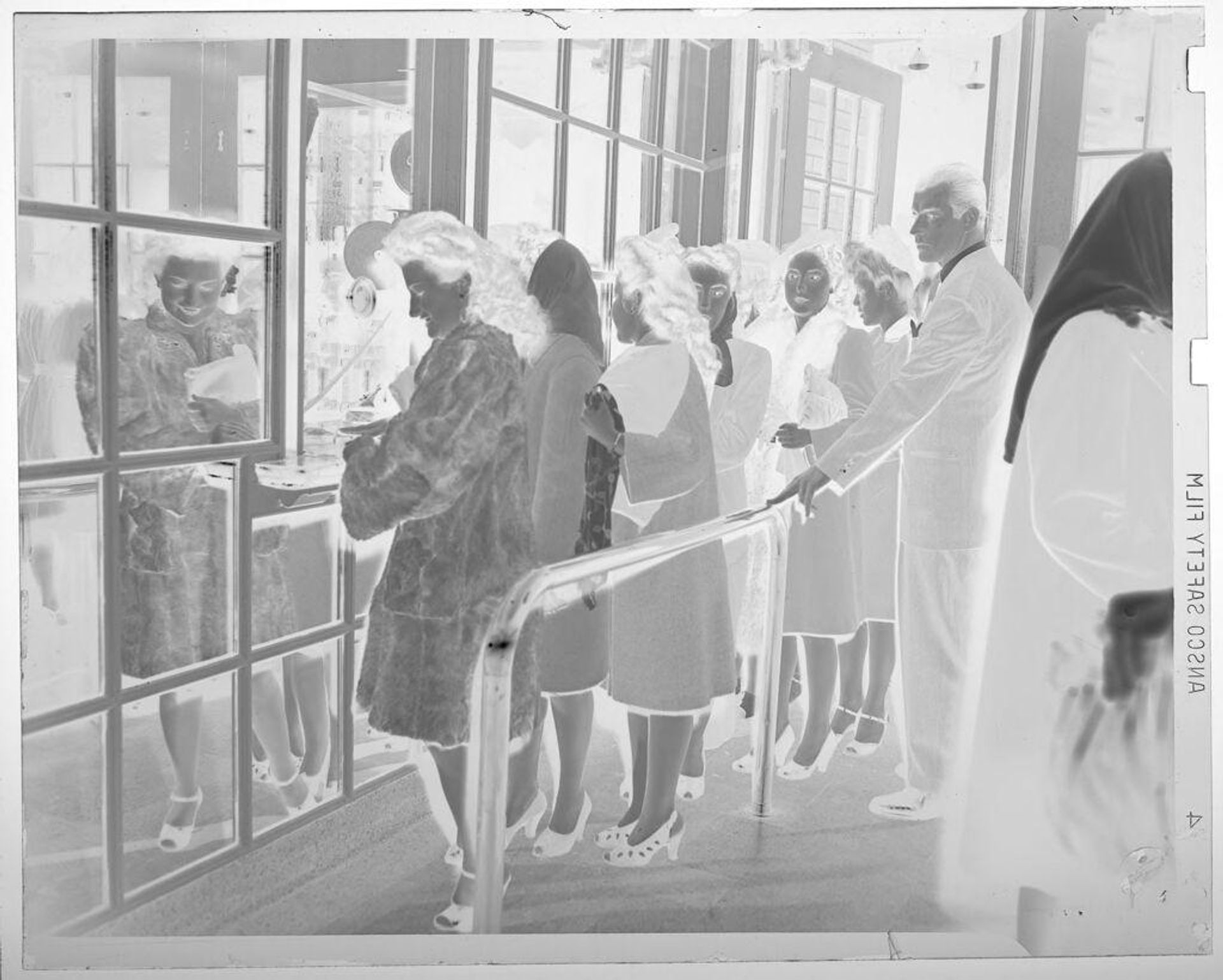 Untitled (several people waiting in line for ticket window) by Jack Gould