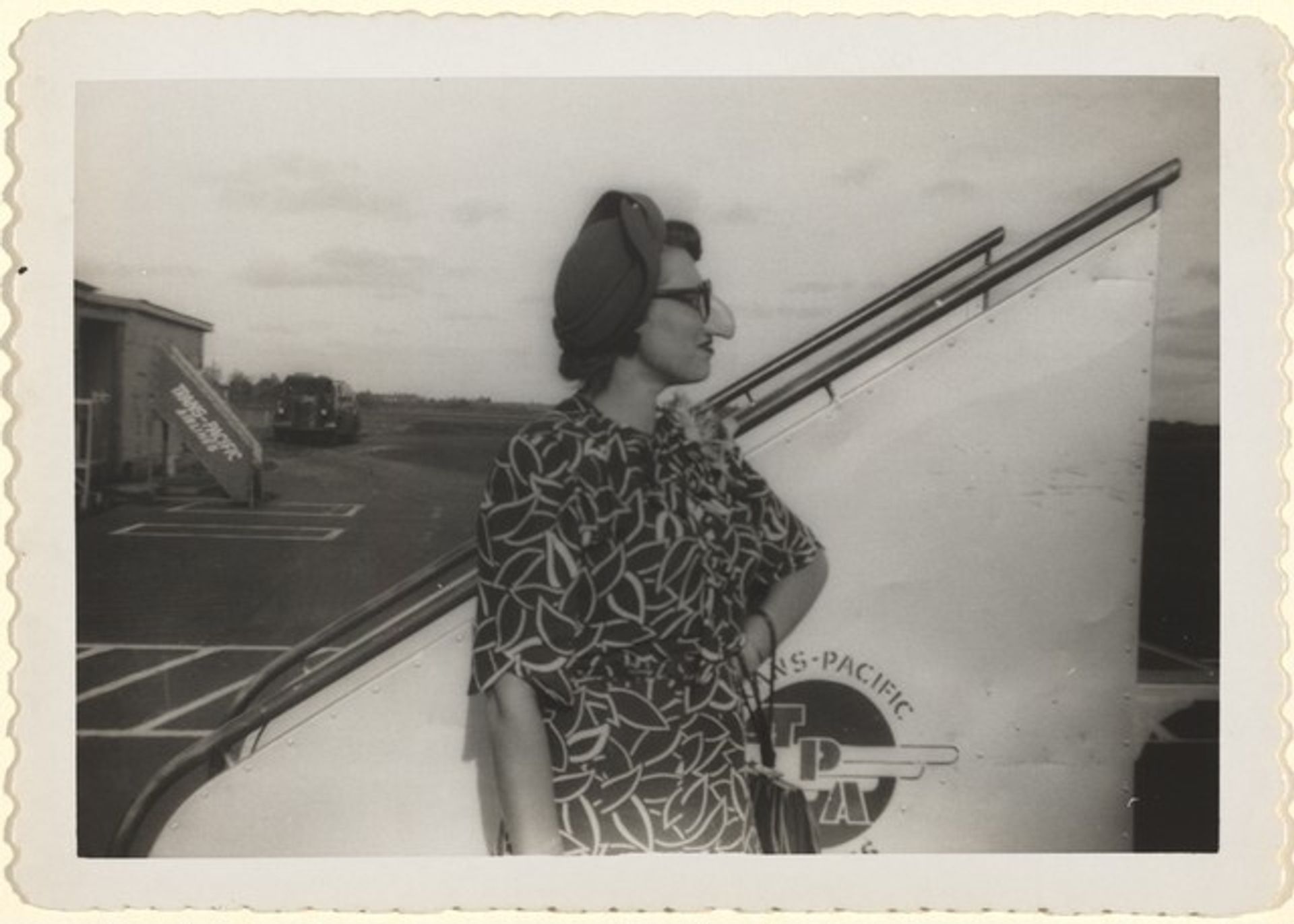 Untitled (Woman with fake nose and glasses on runway) by Anonymous
