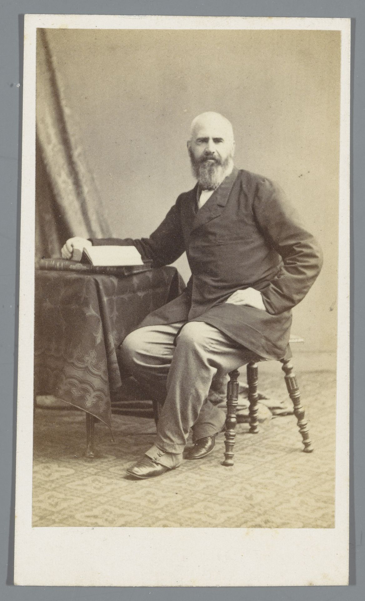 Portret van een onbekende man, zittend aan tafel met een boek in zijn handen by Bisson Frères
