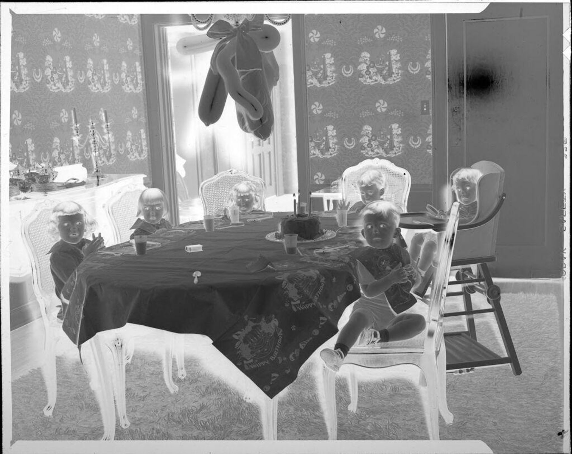 Untitled (children at table for birthday party) by John Howell