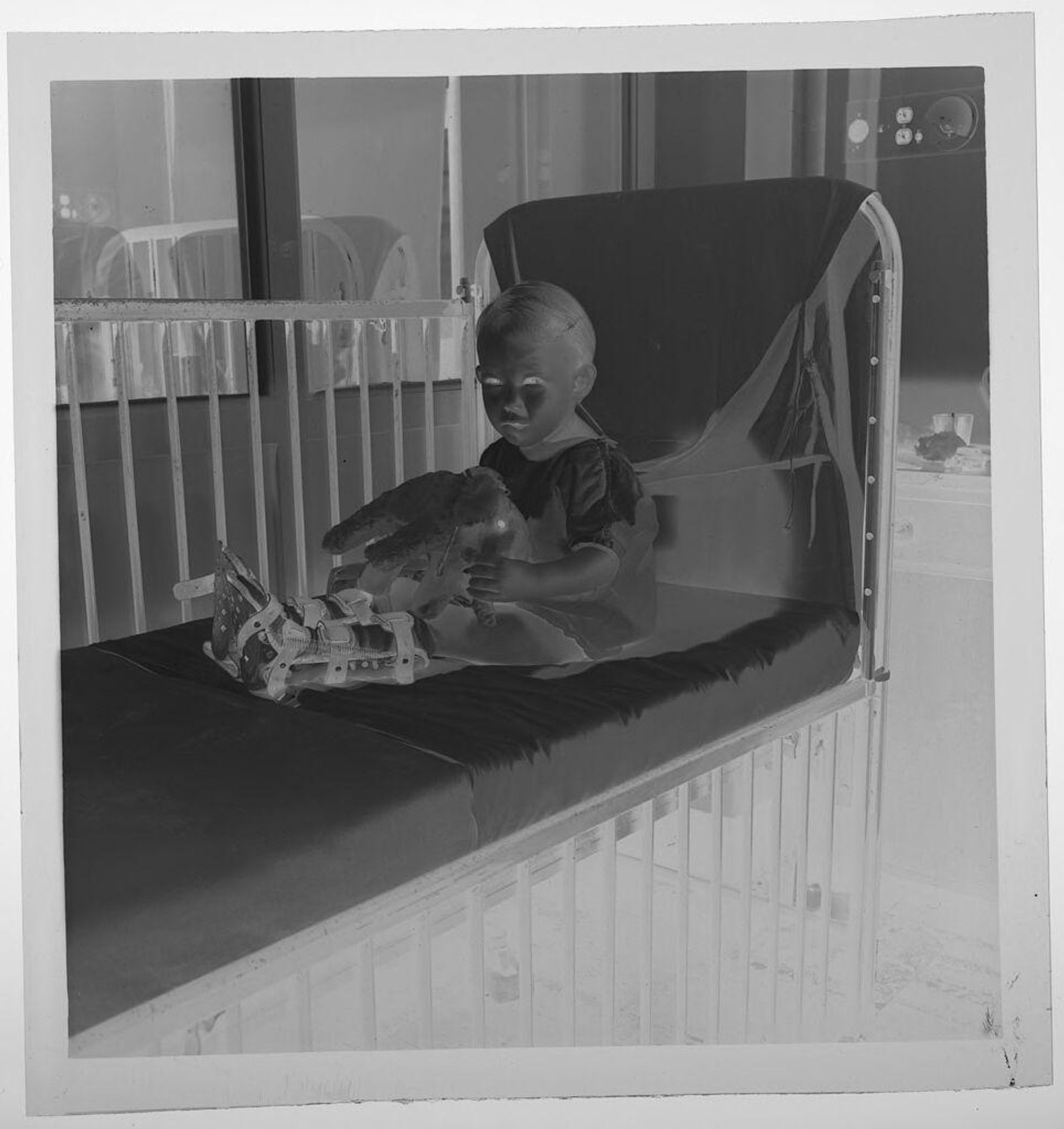 Untitled (child with polio on hospital bed) by Jack Gould
