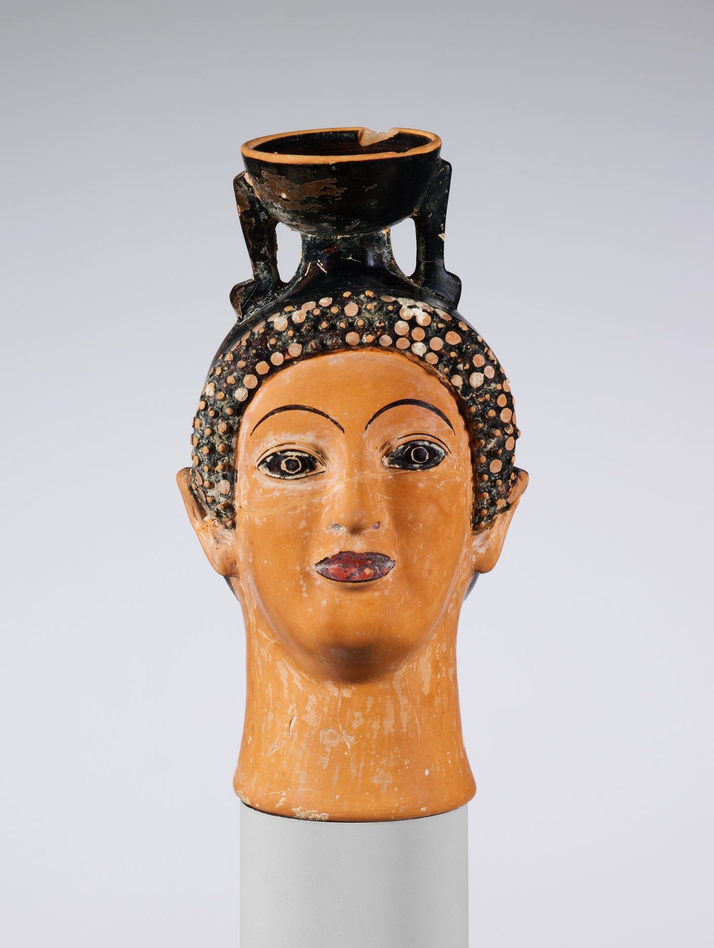 Terracotta aryballos (perfume bottle) in the shape of a woman's head by Oxford Class of Head Vases