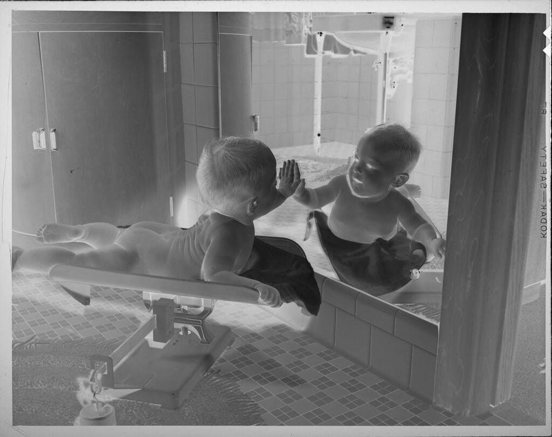 Untitled (baby on scale looking into mirror) by Lucian and Mary Brown