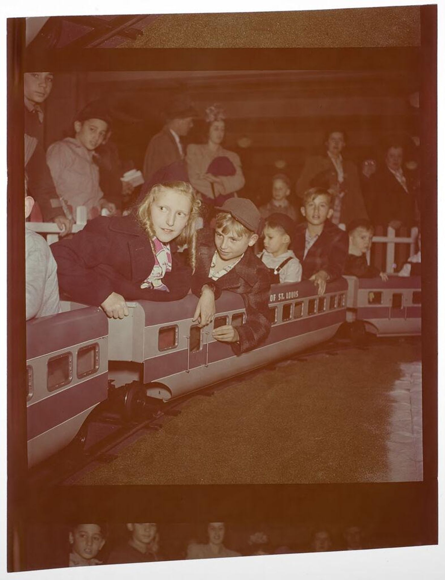 Untitled (children riding on toy train) by Jack Gould