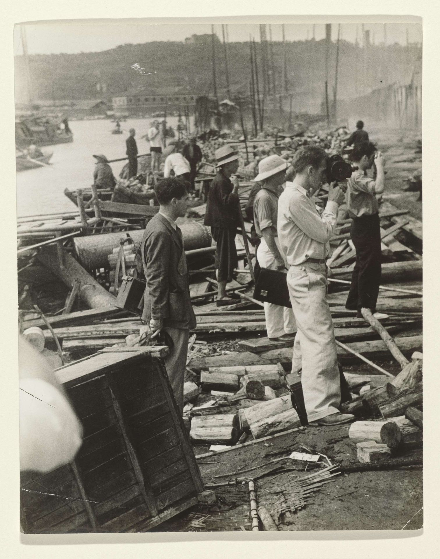Joris Ivens, John Fernhout and Robert Capa at Work in the Bombed City of Hankow by Anonymous