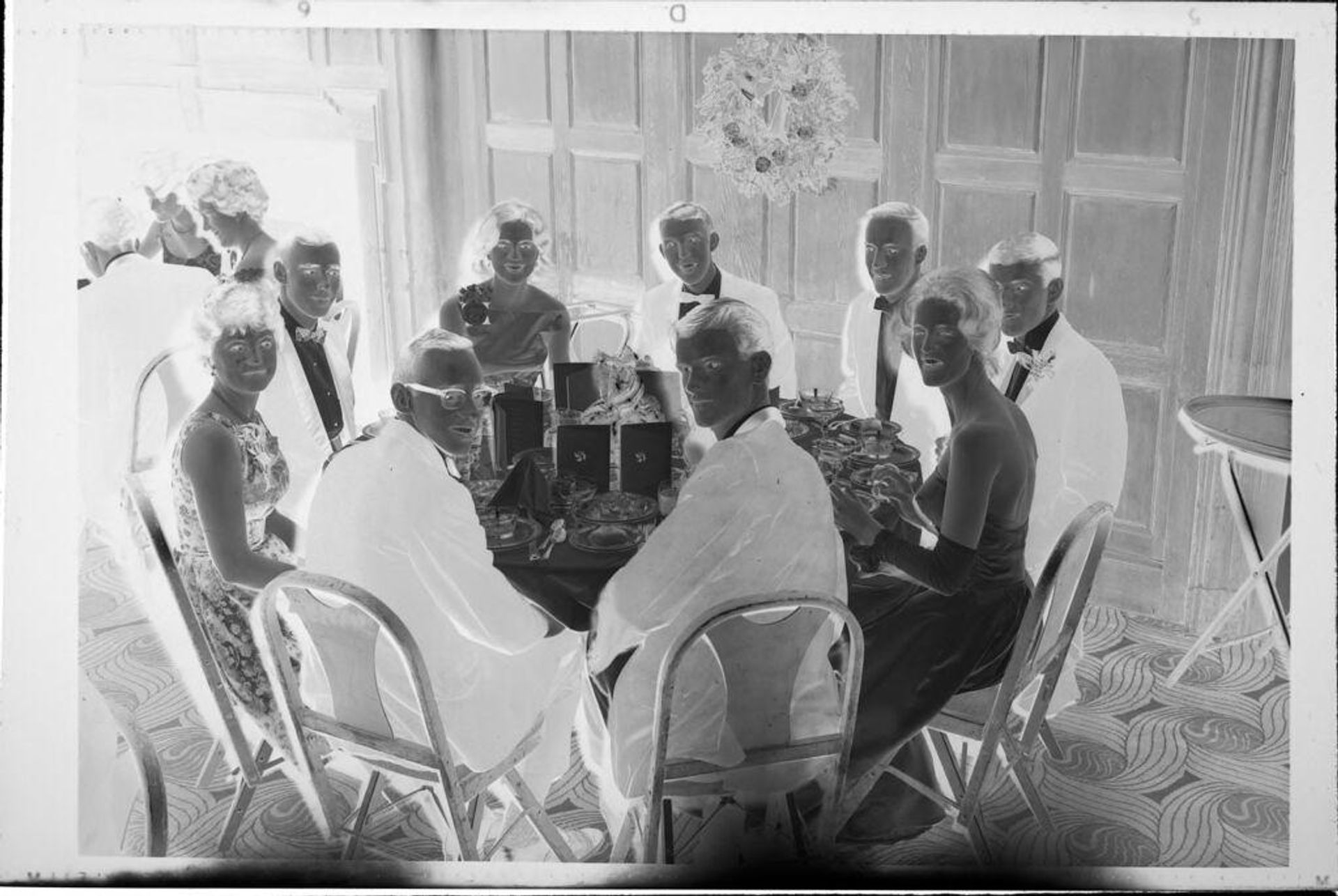 Untitled (young men and women at table at ball) by Robert Burian