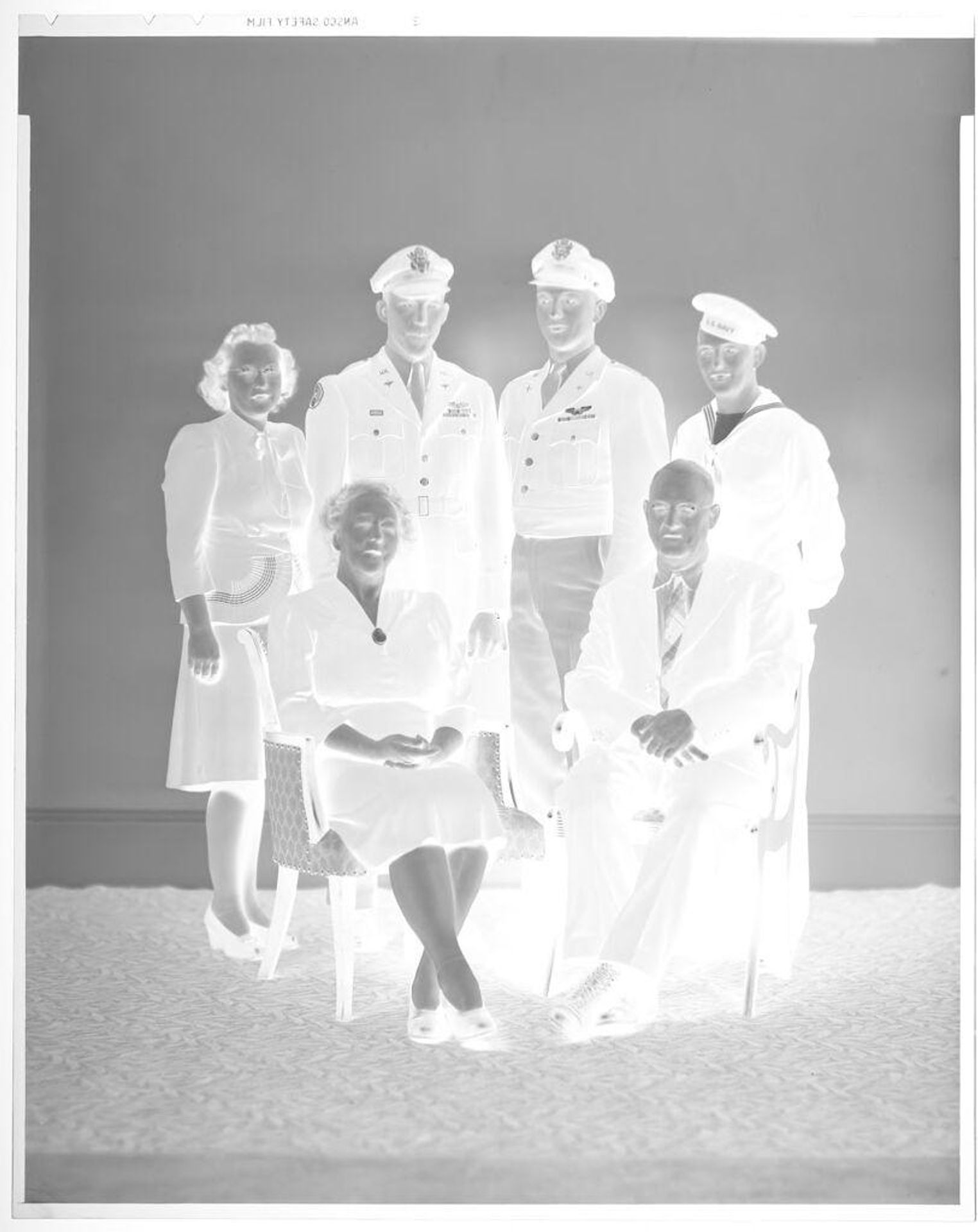 Untitled (family portrait with three men in uniform) by John Deusing