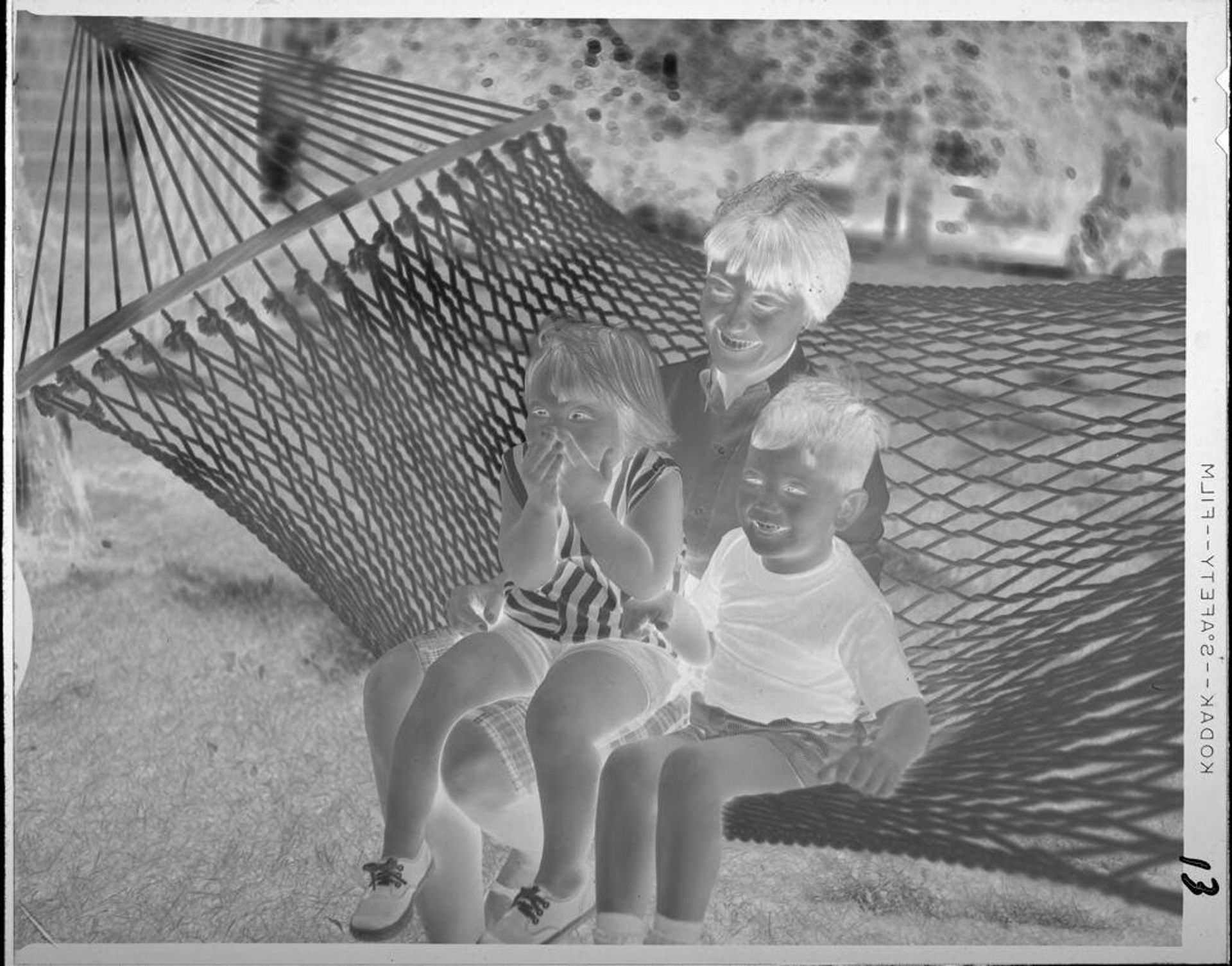 Untitled (woman and children on hammock) by Lucian and Mary Brown