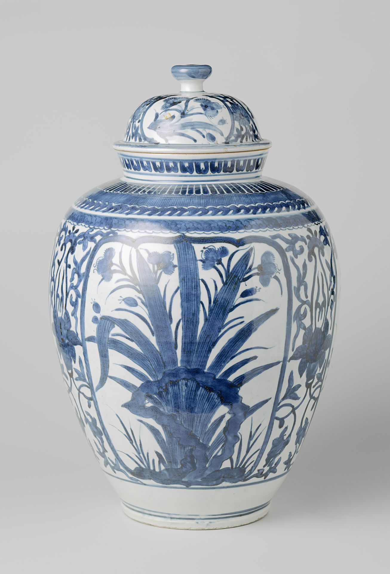 Ovoid covered jar with flowering plants near rocks and lotus scrolls by Anonymous