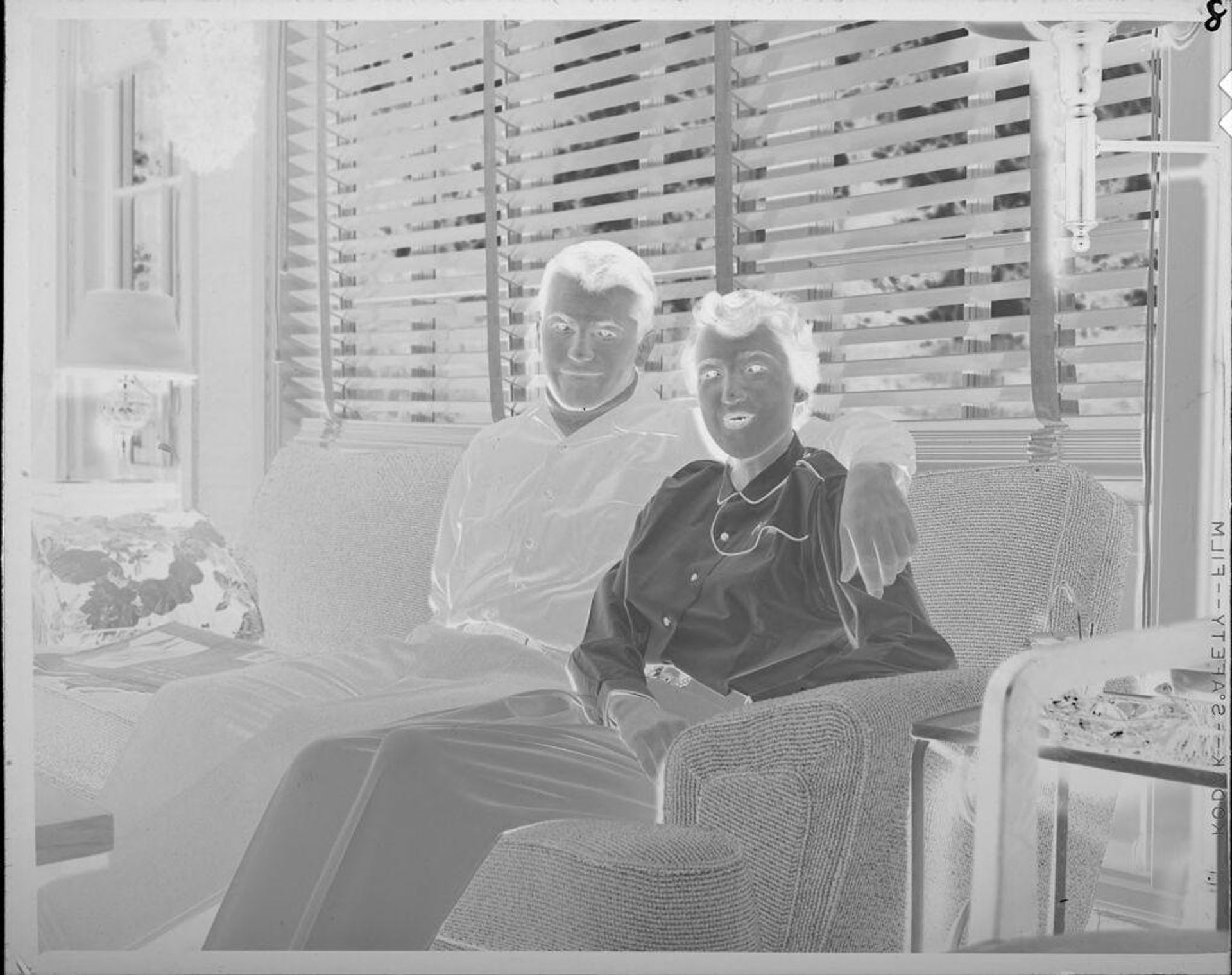 Untitled (yound man and woman on couch) by Lucian and Mary Brown