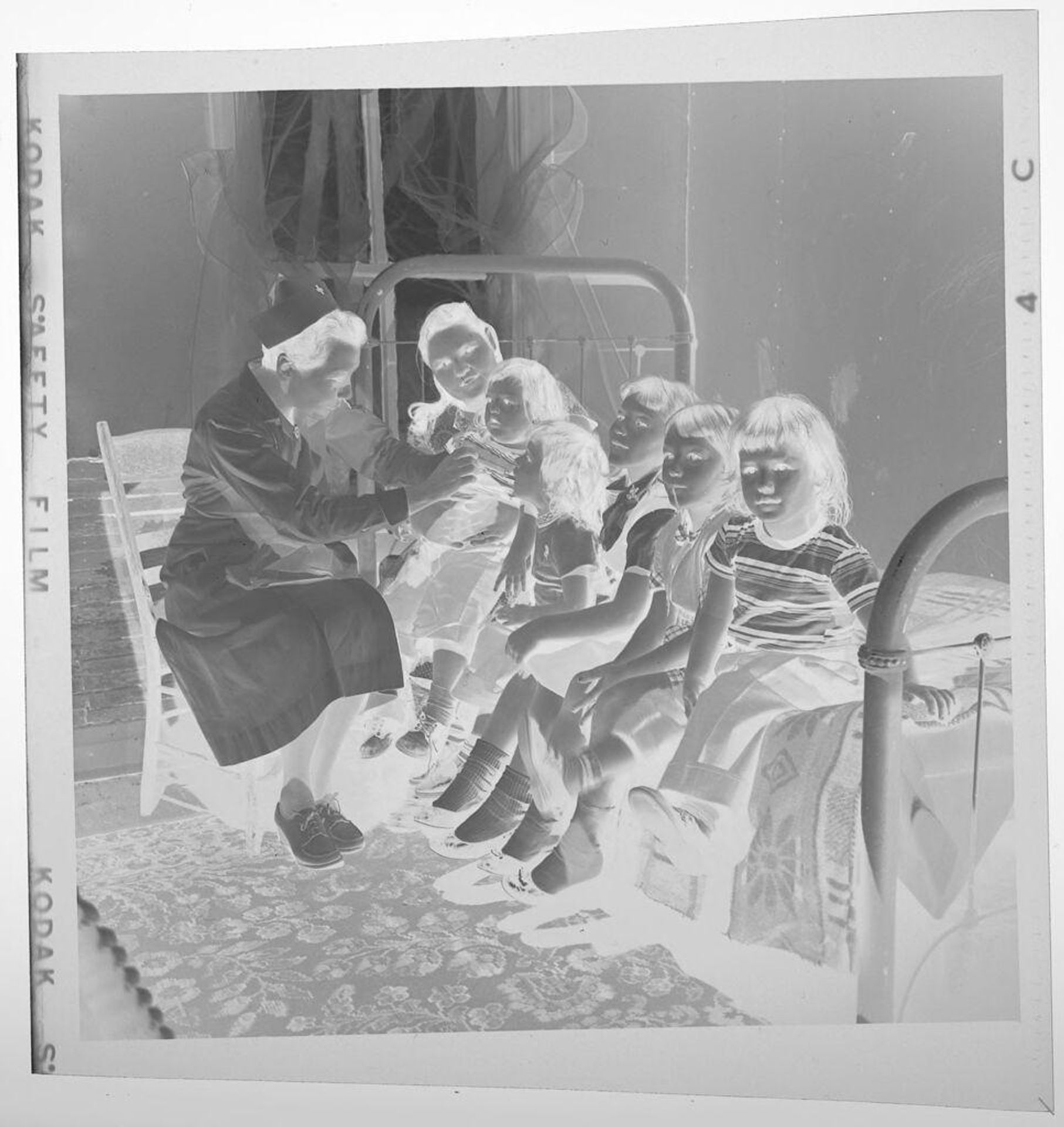 Untitled (nurse inspecting children on bed) by Jack Gould