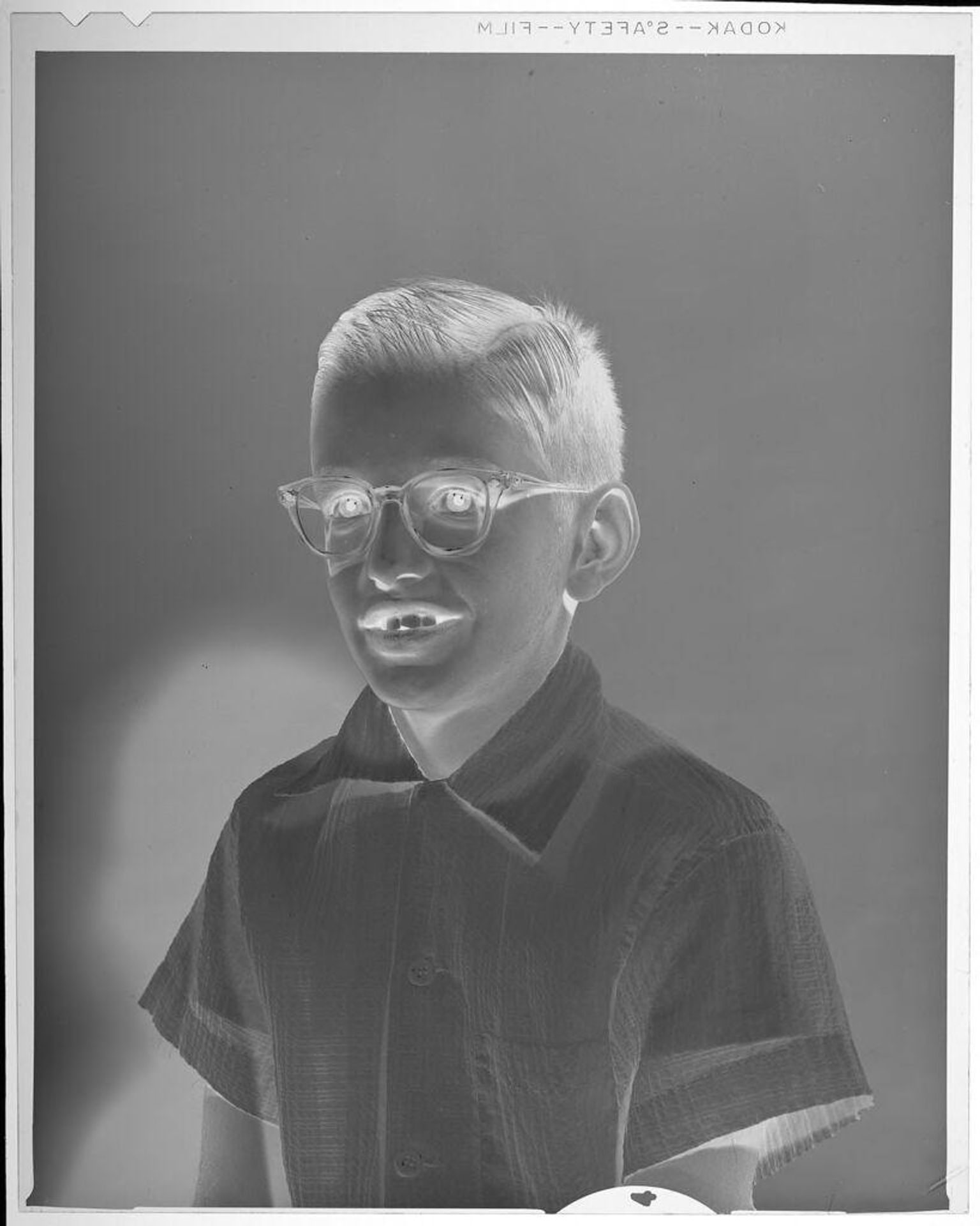 Untitled (portrait of young boy wearing glasses) by Lucian and Mary Brown