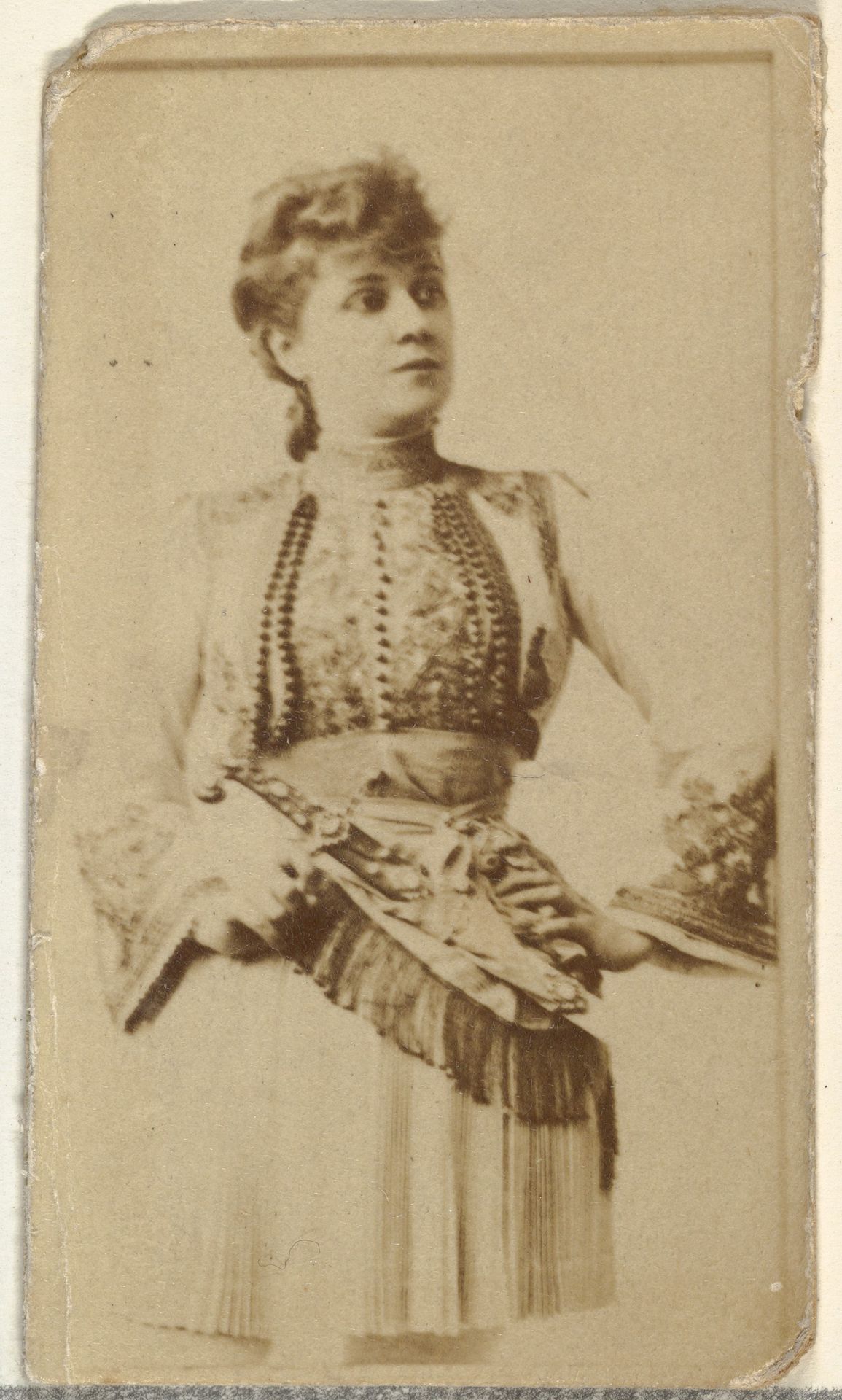 [Actress wearing fringed scarf], from the Actors and Actresses series (N145-8) issued by Duke Sons & Co. to promote Duke Cigarettes by W. Duke, Sons & Co.