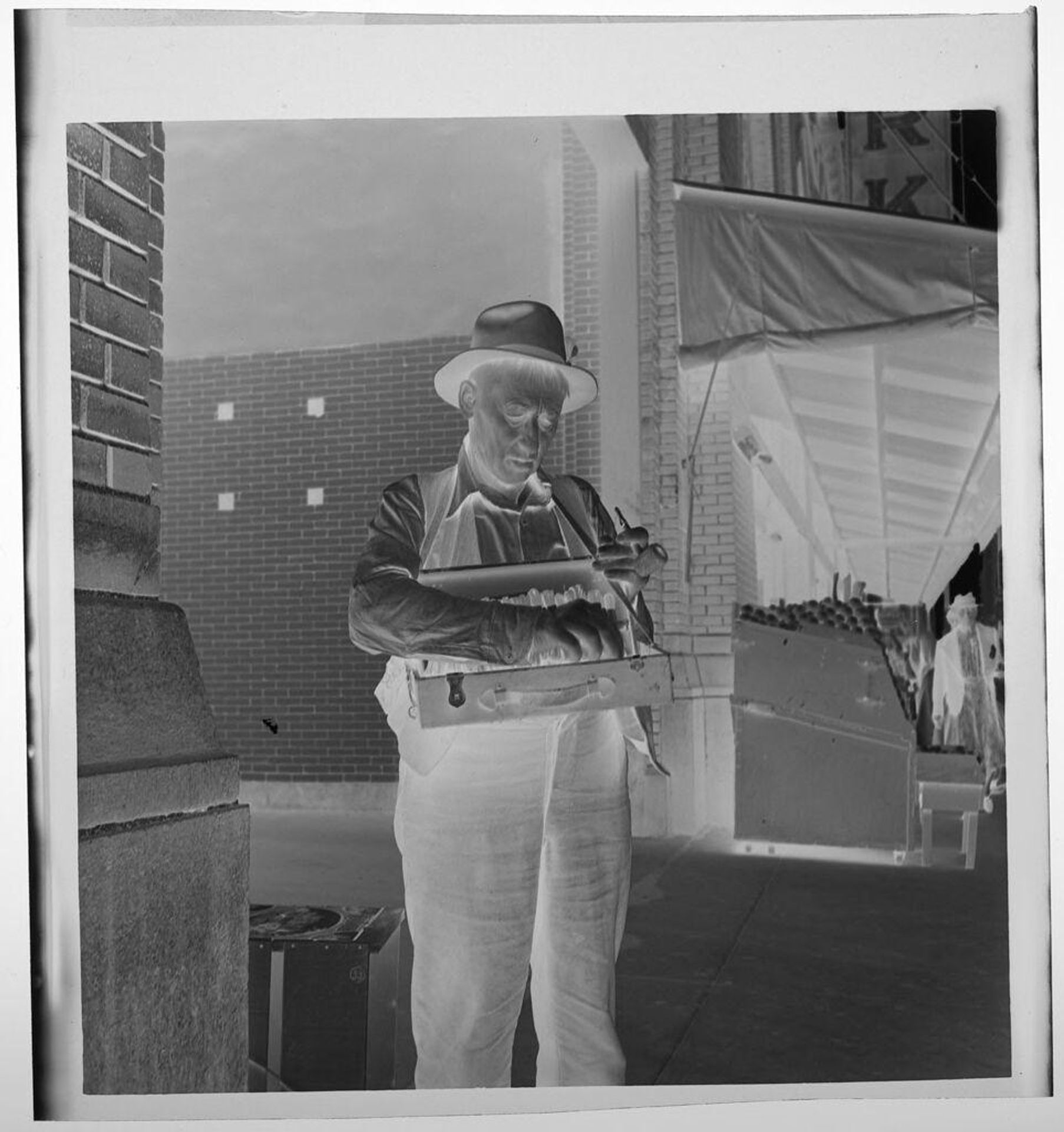 Untitled (man selling things, possibly cigars, from a case around his neck) by Jack Gould