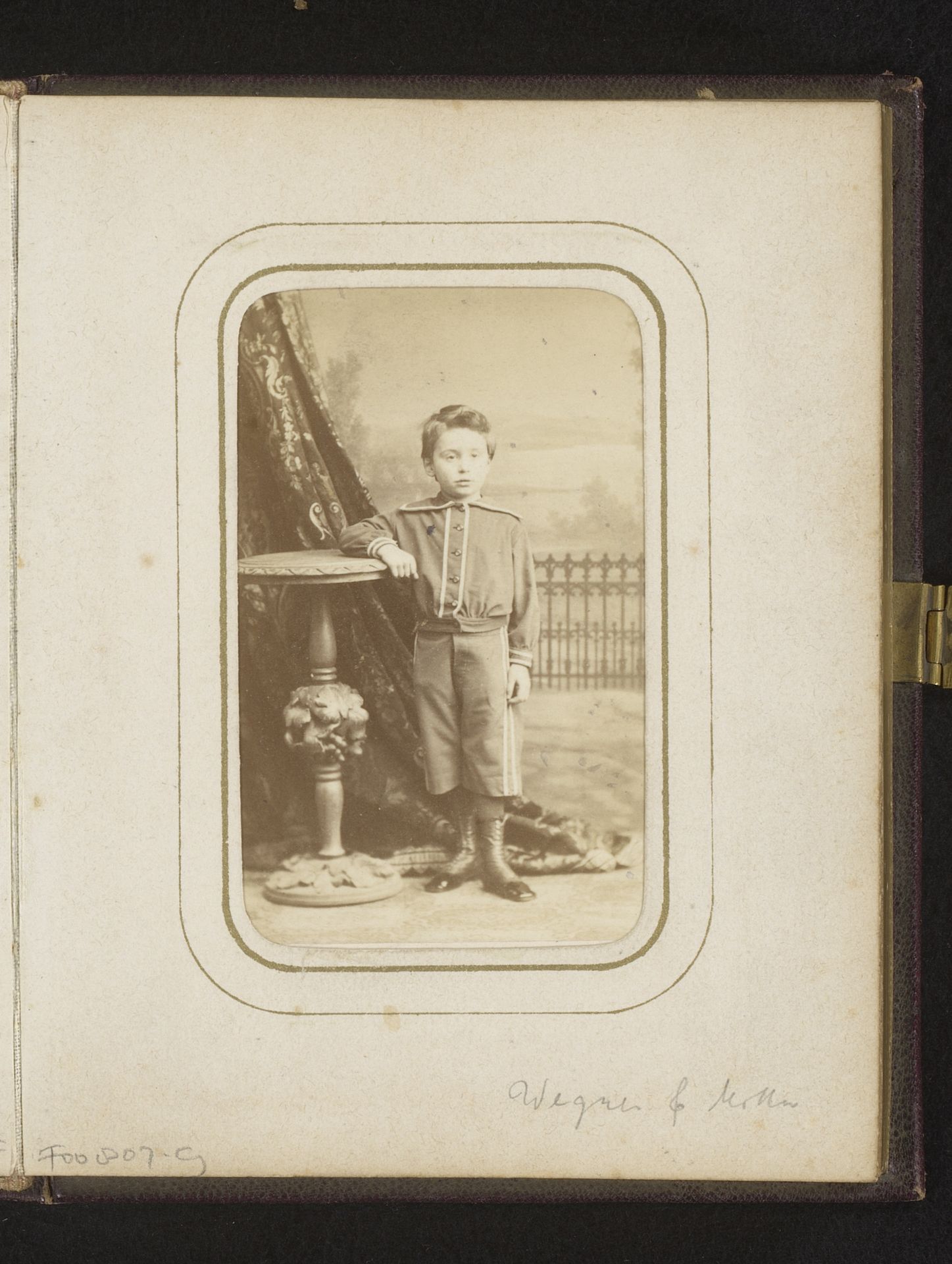 Portret van een jongen, staand bij een tafel by Wegner & Mottu