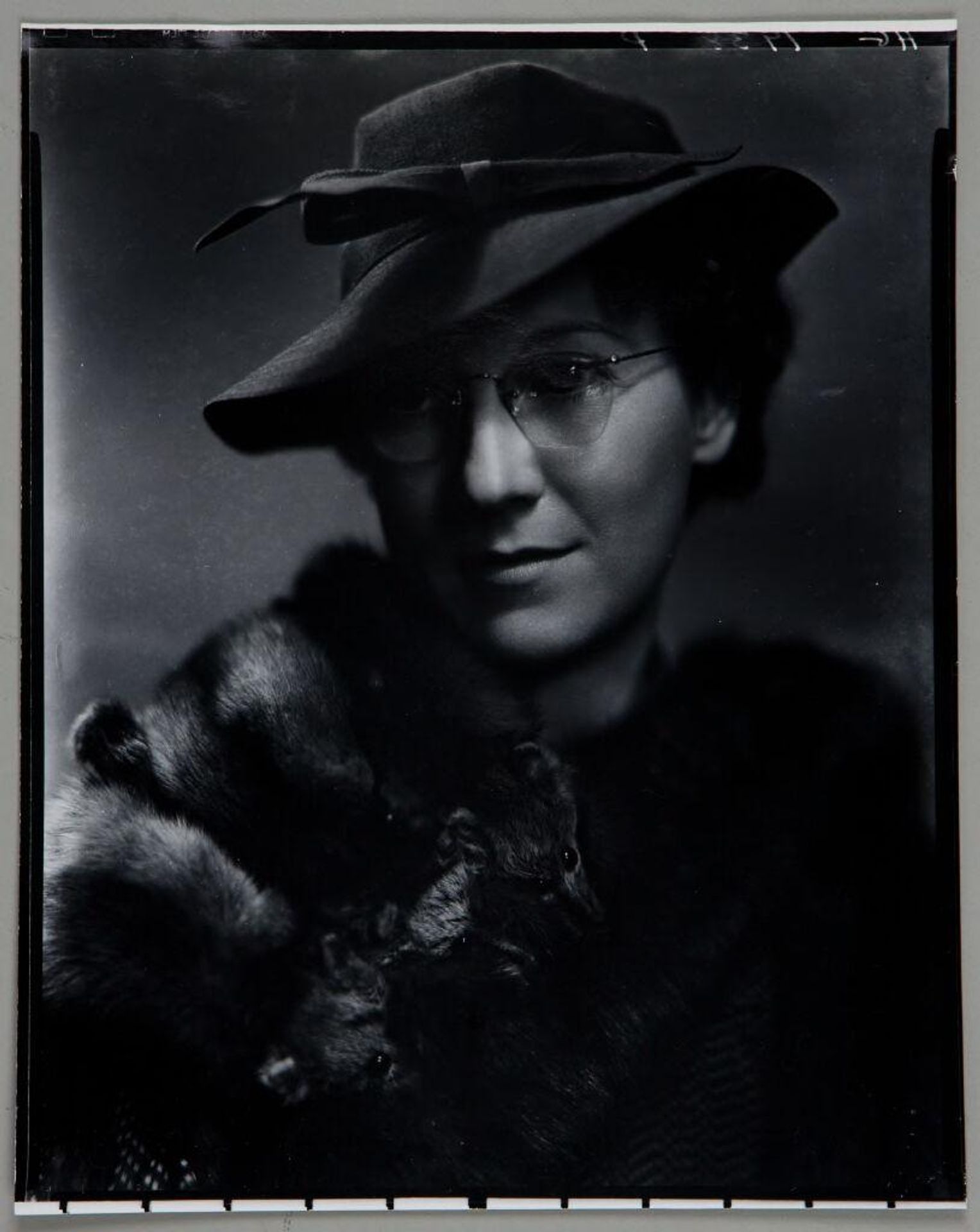 Untitled (woman in hat, glasses, and fur stole with animal heads over shoulder) by Paul Gittings