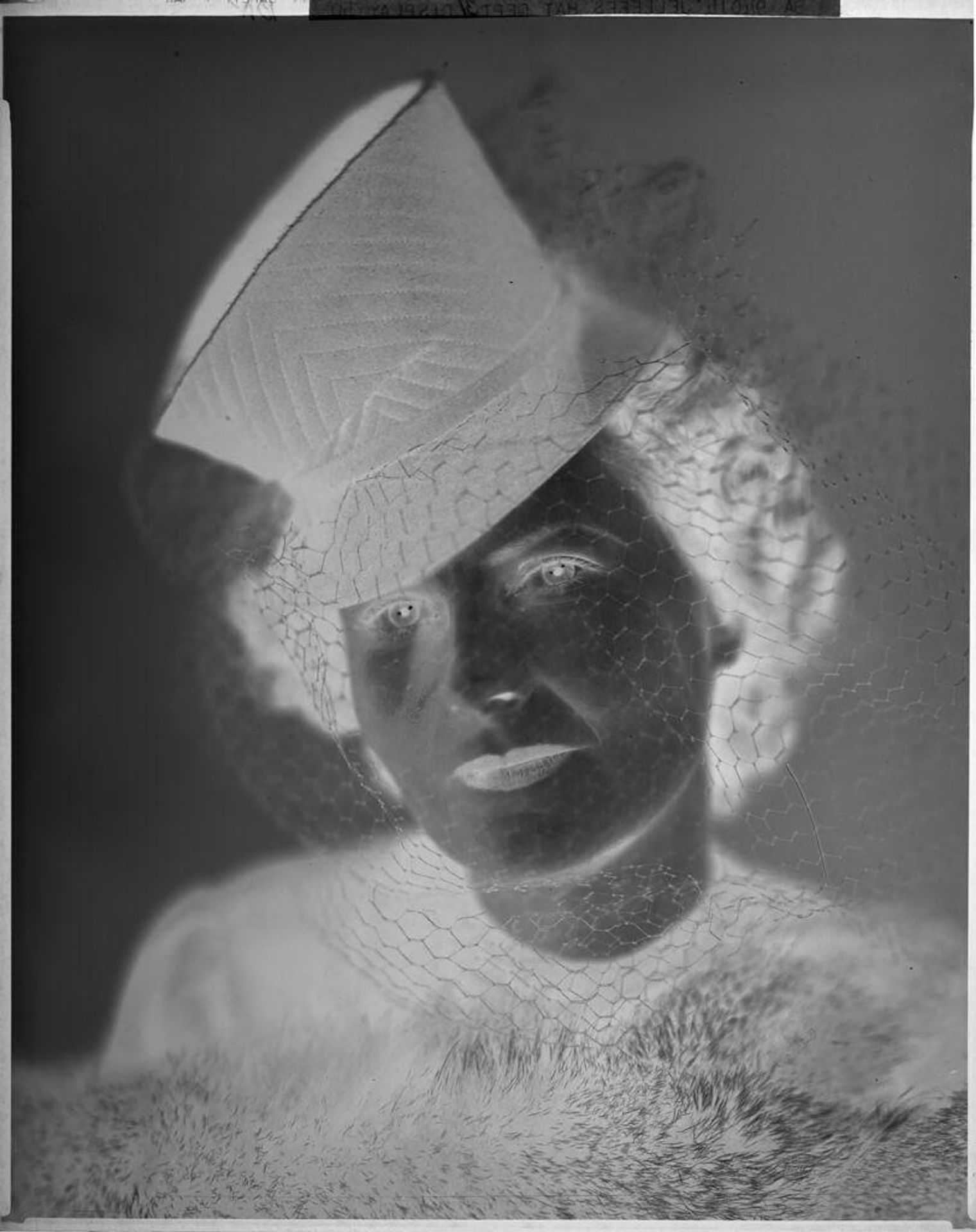 Untitled (woman posed in hat tipped to the side above one eye, veil and fur) by Harris & Ewing