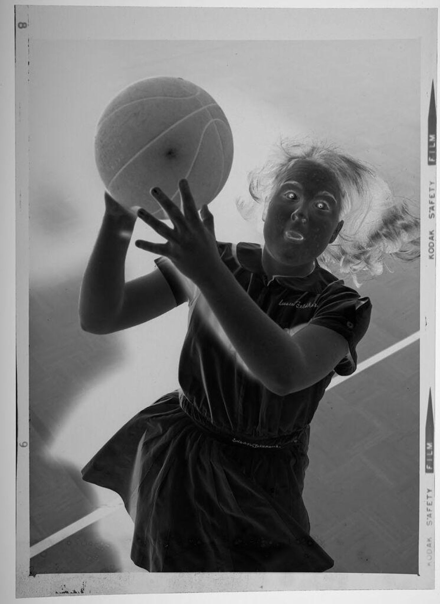 Untitled (girls Catholic high school student jumping with basketball) by Martin Schweig