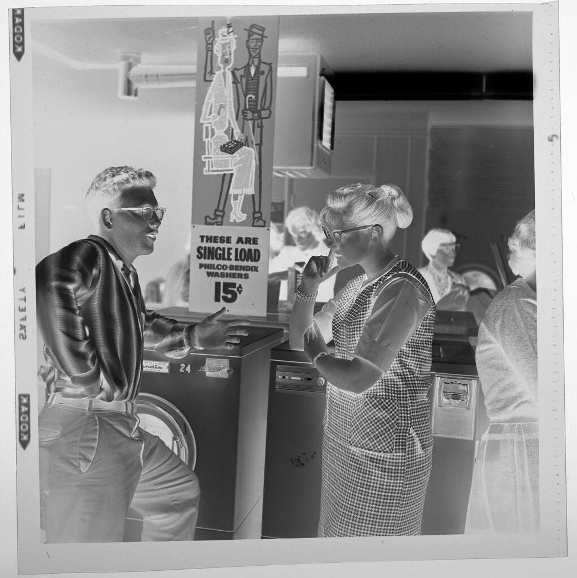 Untitled (party in laundromat, man and woman talking) by Jack Gould