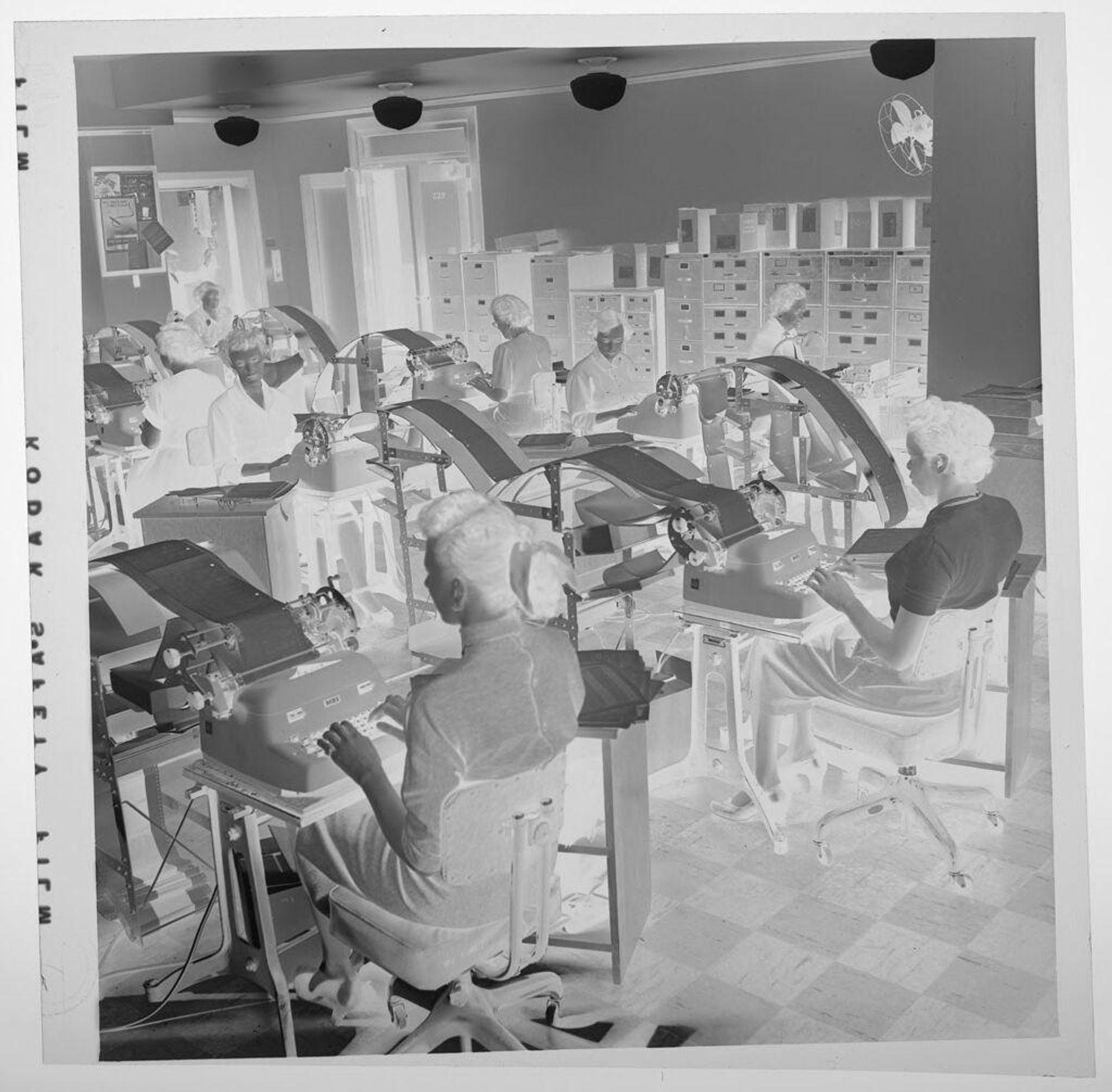 Untitled (room full of women working at typewriters) by Jack Gould