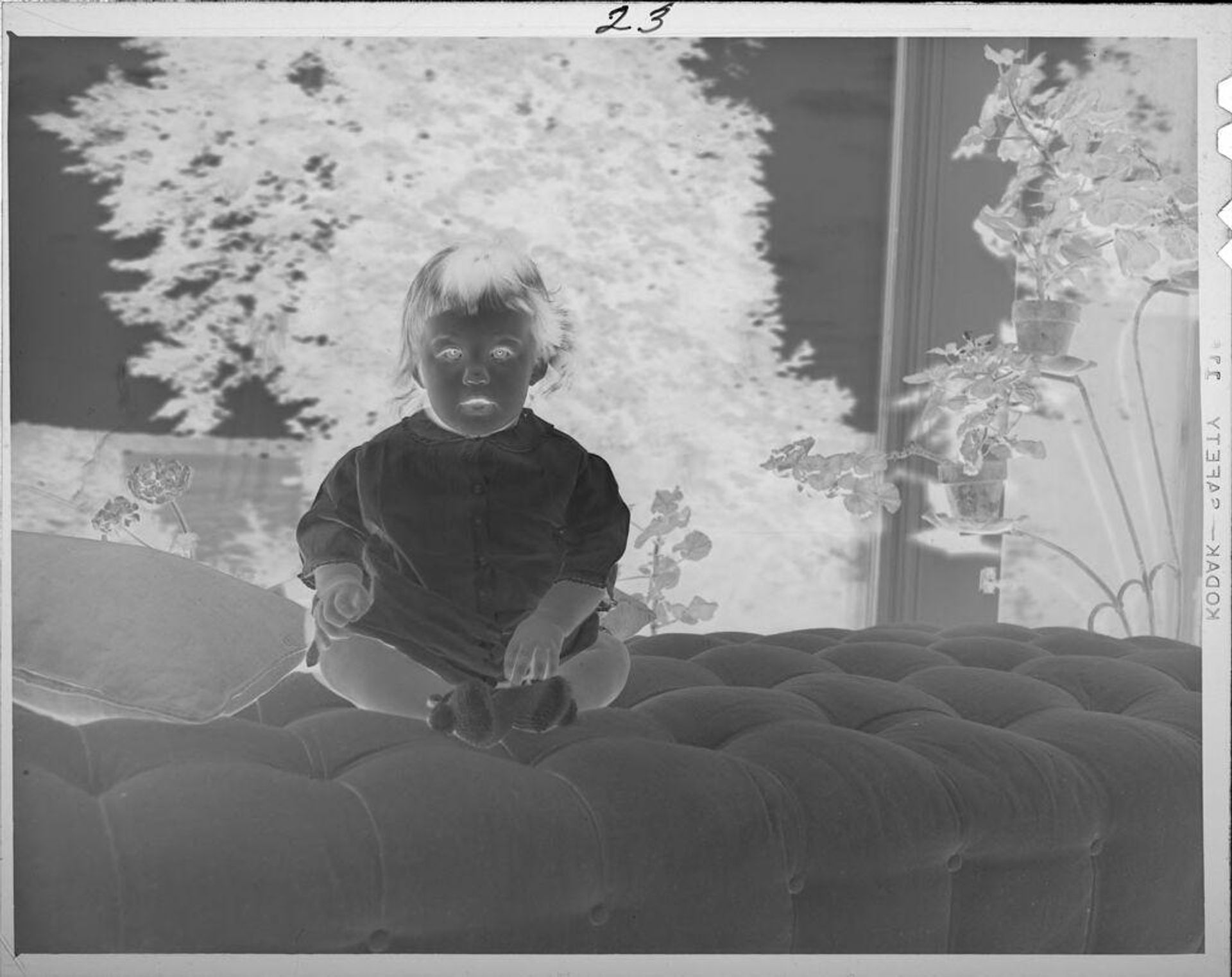 Untitled (little girl on couch in front of window) by Lucian and Mary Brown