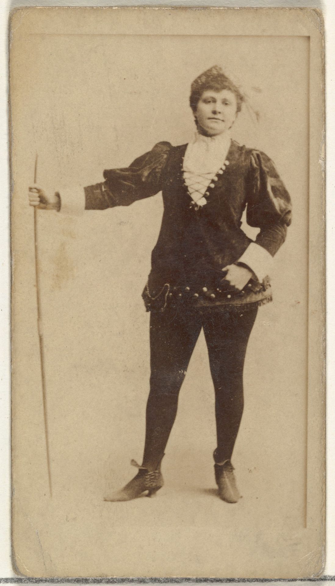 [Actress standing with long staff], from the Actors and Actresses series (N145-8) issued by Duke Sons & Co. to promote Duke Cigarettes by W. Duke, Sons & Co.