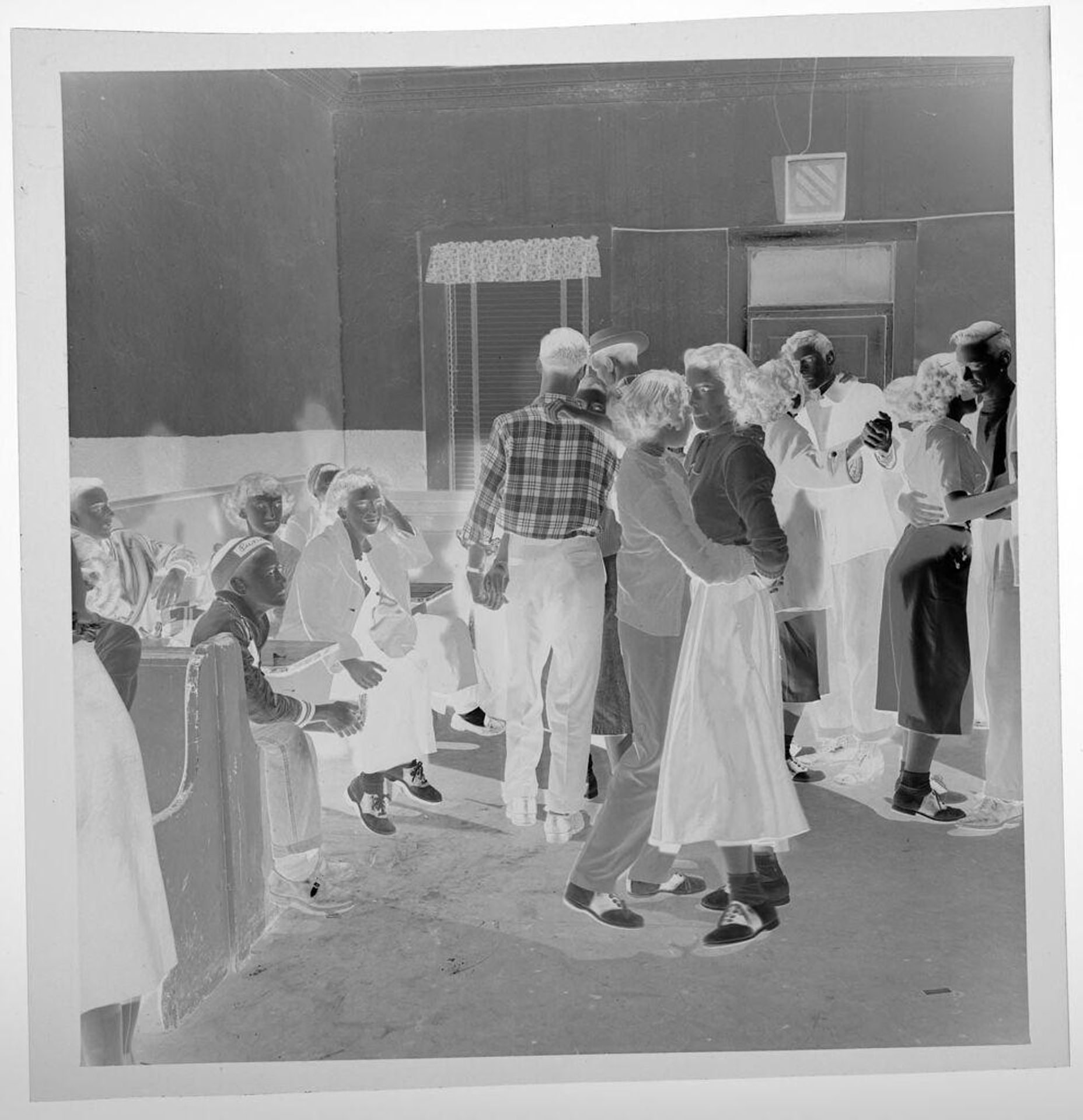 Untitled (people sitting at booths in pub, several people dancing together) by Jack Gould