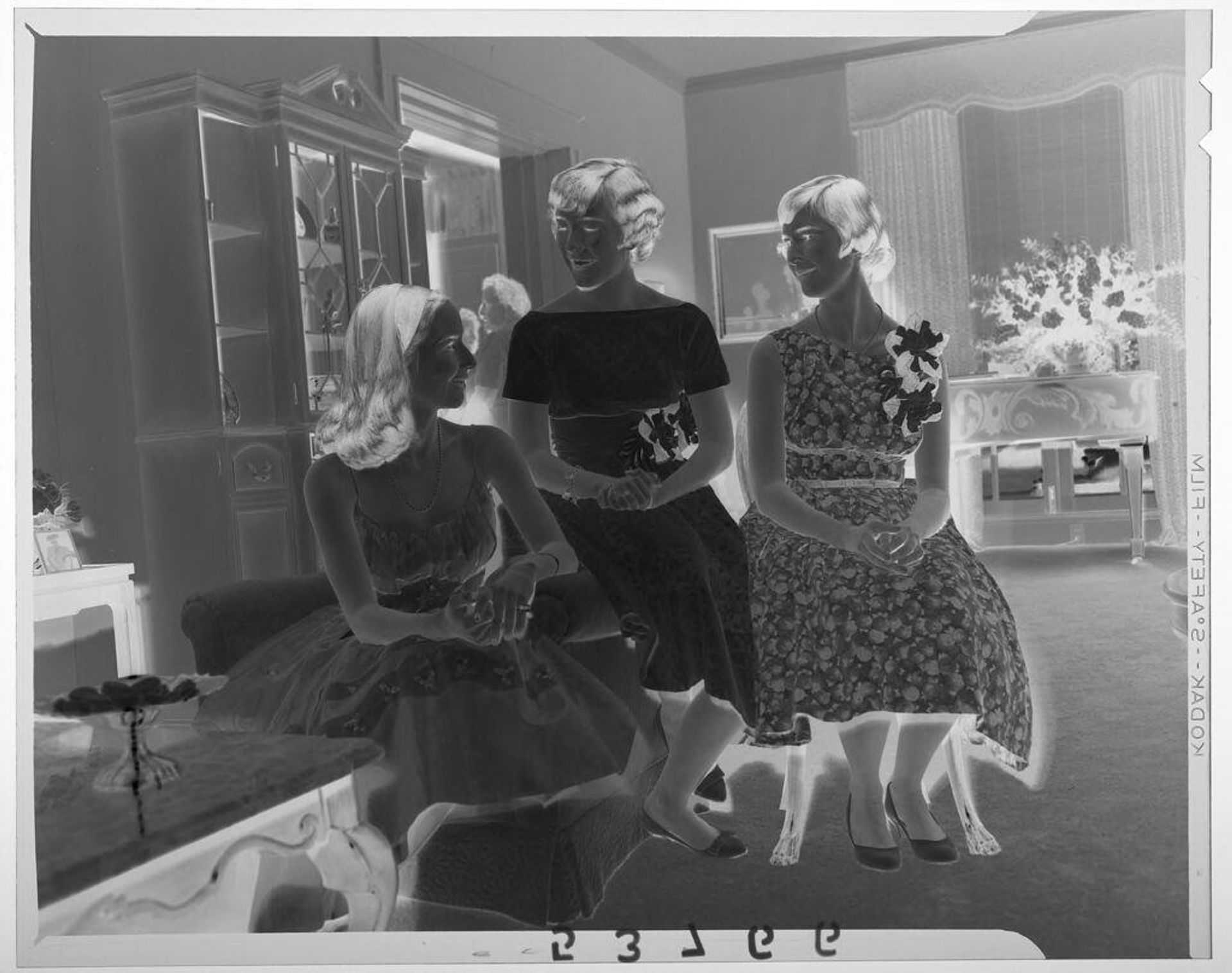 Untitled (three young women chatting in fancy living room at party) by Martin Schweig