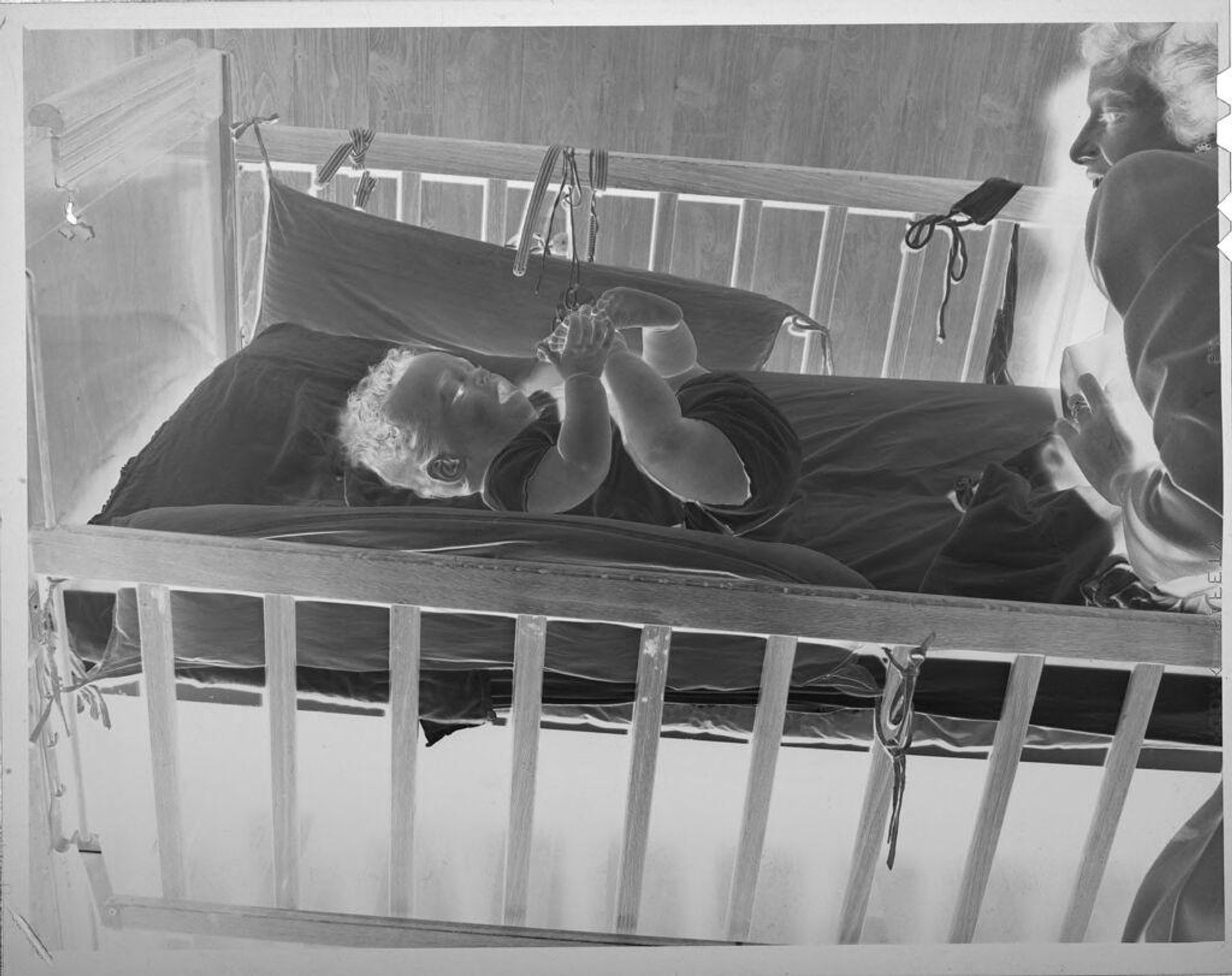 Untitled (baby in crib) by Lucian and Mary Brown
