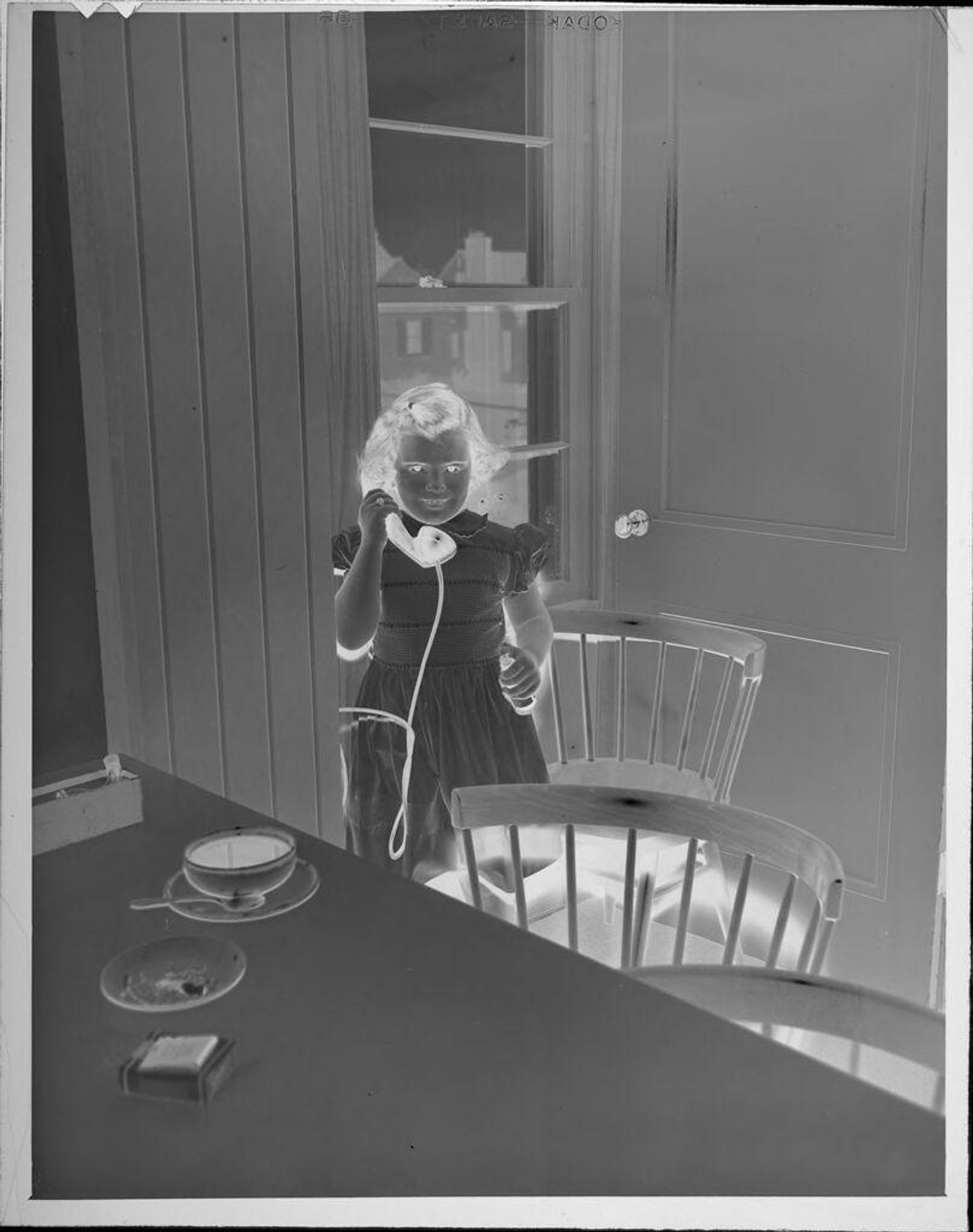 Untitled (little girl holding telephone) by Lucian and Mary Brown