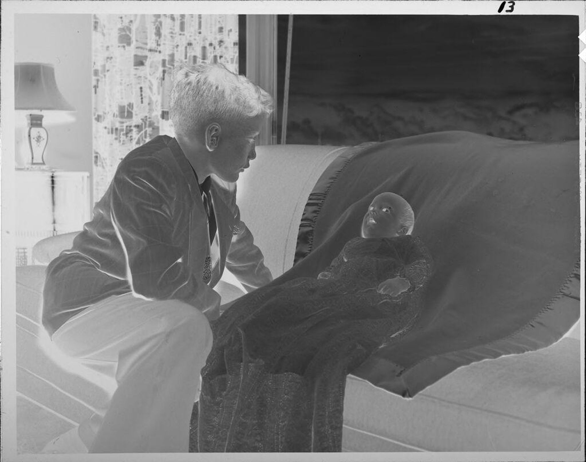 Untitled (boy with baby on couch) by Lucian and Mary Brown