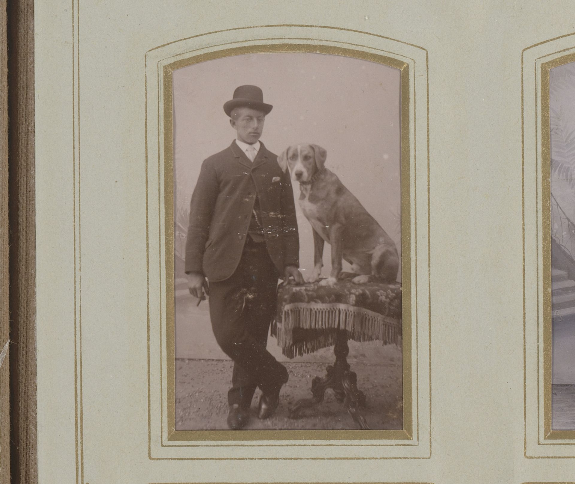 Portret van een jonge man bij een tafel met een hond by Gebroeders IJpma
