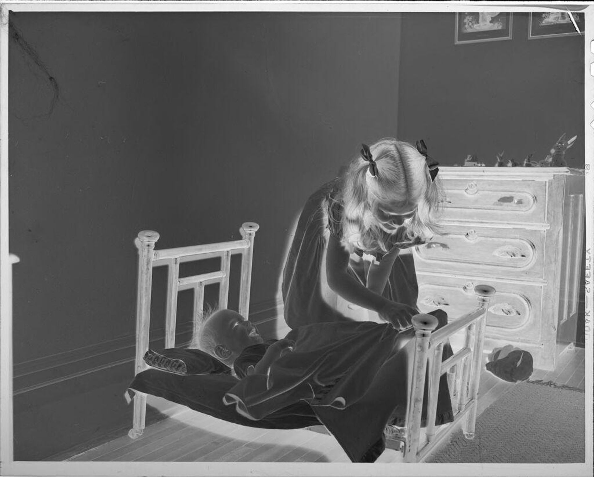 Untitled (girl with baby in tiny bed) by Lucian and Mary Brown